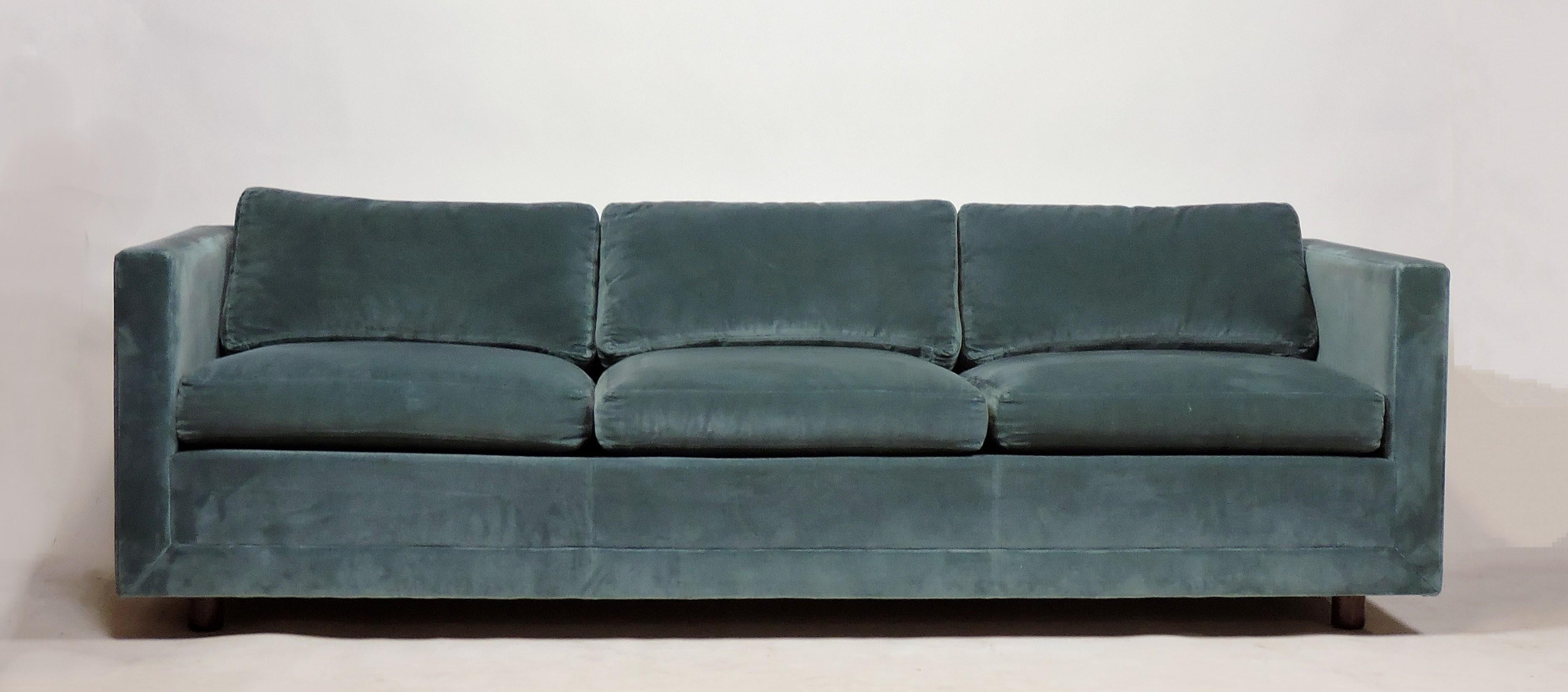 Beautiful and comfortable three-seat tuxedo sofa in the style of Edward Wormley or Harvey Probber. This sofa is upholstered in a teal color velvet and has three inch high wooden legs which give it a floating appearance. All of the cushions are