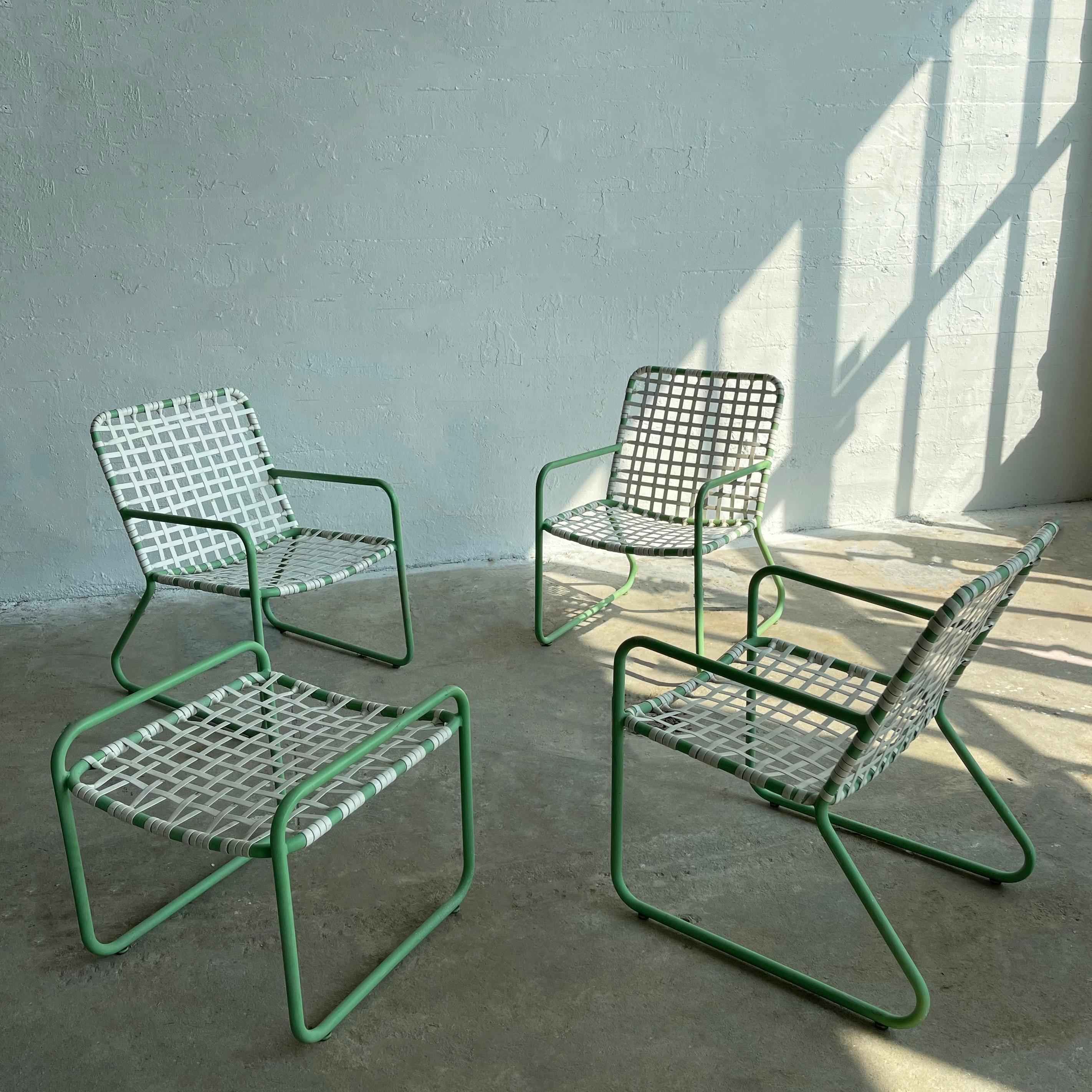 Classic, mid-century modern, four piece, outdoor, patio seating set by Brown Jordan features three armchairs and one ottoman.  The mint green painted tubular metal frames with woven white plastic seats and backs are roomy, comfortable and light