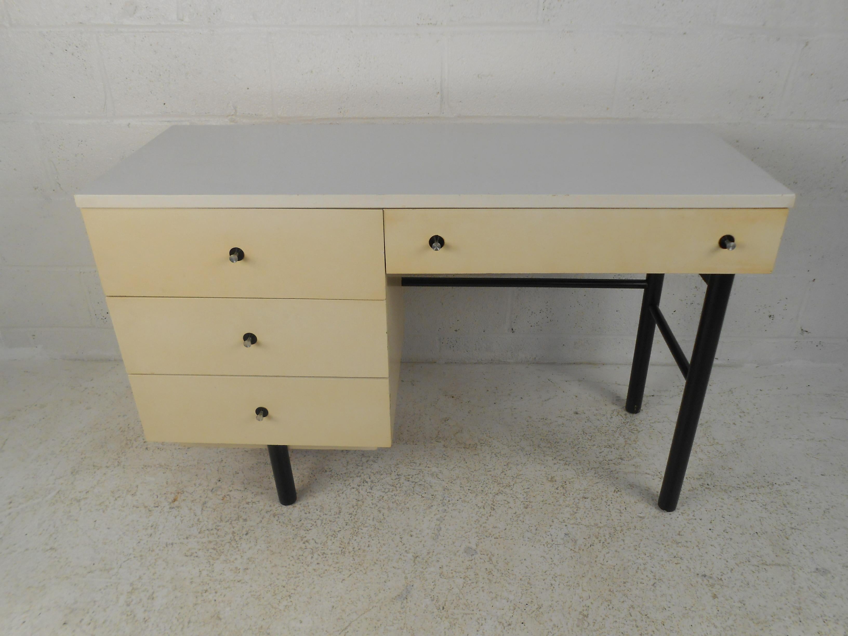 This Mid-Century Modern desk by Stanley Furniture offers ample storage space and durable Formica desktop. Perfect writing desk for home office or children's space. 

Please confirm item location (NY or NJ) with dealer.