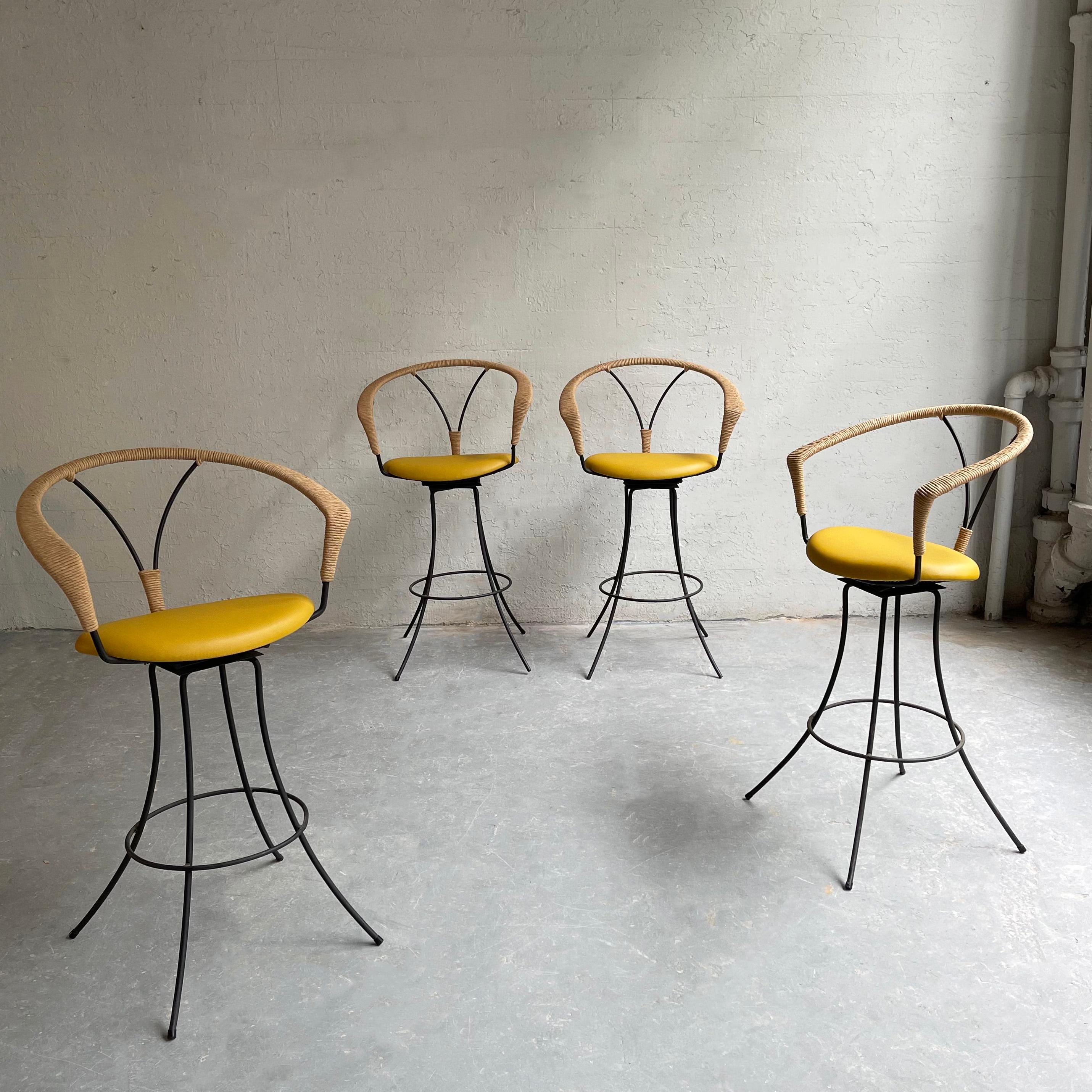 Fantastic set of 4 bar stools in the style of Arthur Unamoff or Danny Ho Fong feature wrought iron frames with newly upholstered, perforated vinyl seats with woven rush details. The stool footprint is 26 inches diameter.
