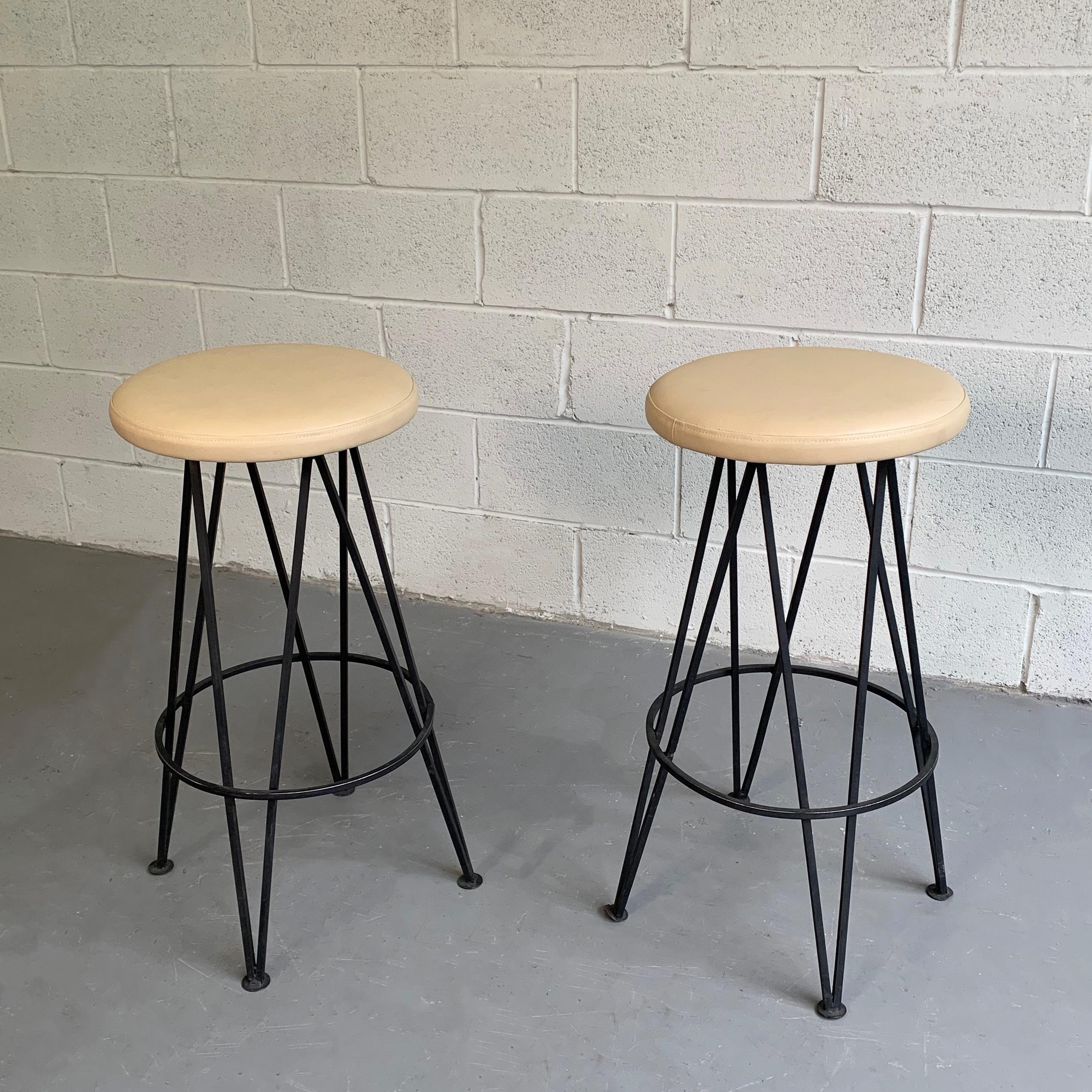Pair of Mid-Century Modern, bar stools feature hairpin, wrought iron bases with newly upholstered, measures: 14 inch diameter, blush-beige vinyl seats.