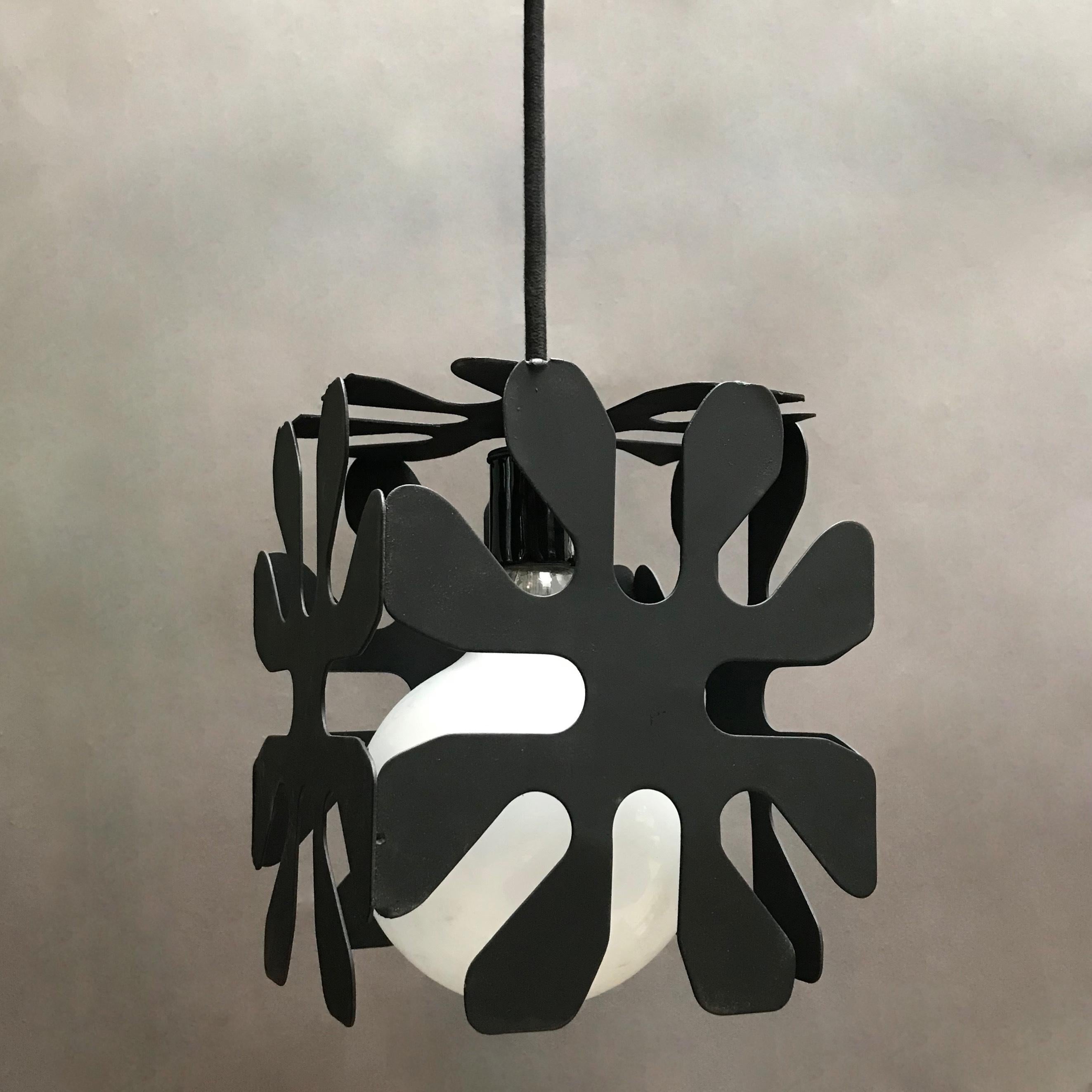 Mid-Century Modern, wrought iron pendant light features a cubed flower motif with 50 inches of cord. Shown with a large opaque bulb but can be used with the bulb of your choice.