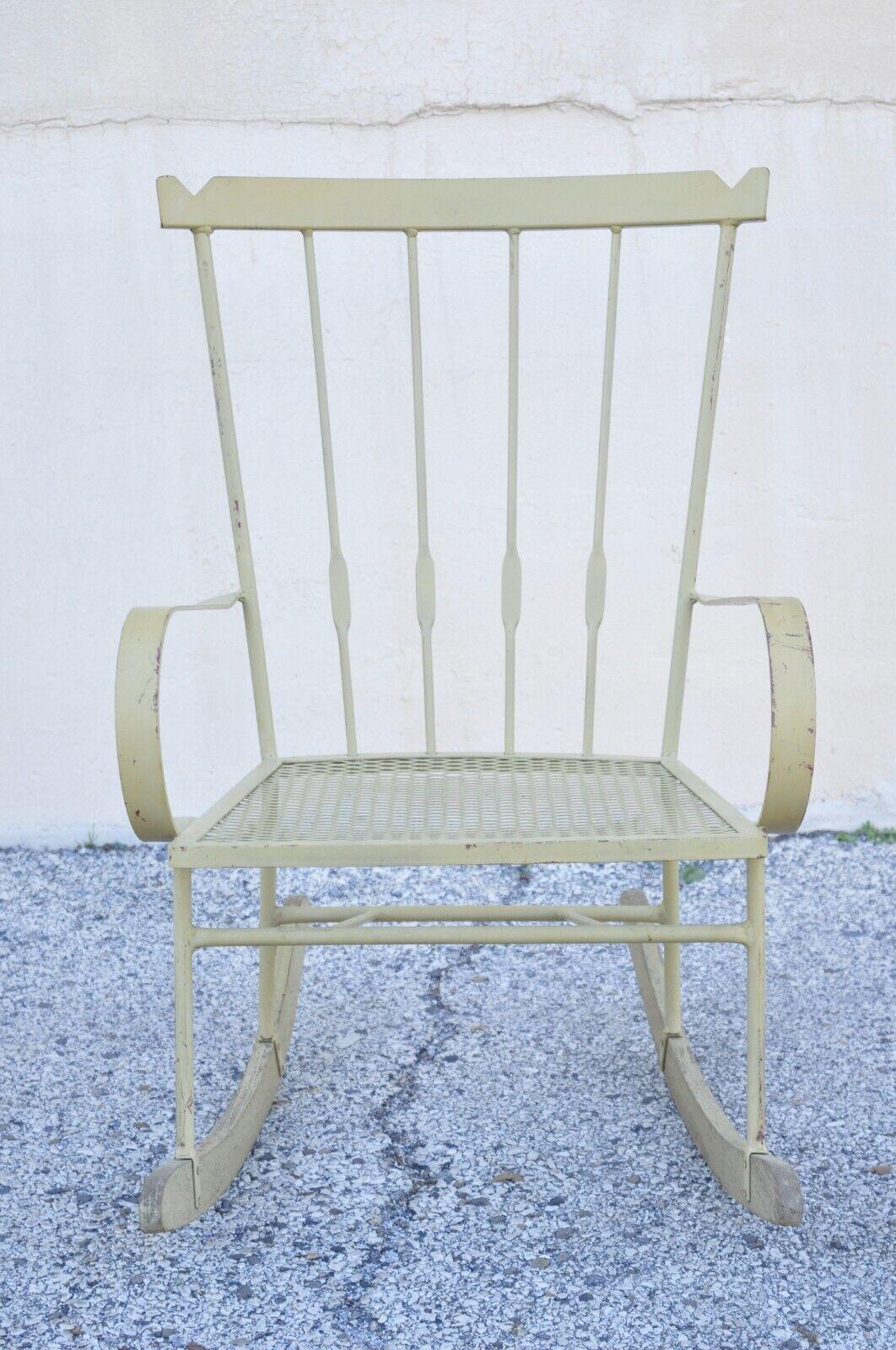 Mid-Century Modern wrought iron rocking chair after Salterini and Arthur Umanoff. Item features wooden runners, wrought iron frame, yellow finish, very nice vintage item, quality craftsmanship, maker unconfirmed, in the style of Arthur Umanoff,