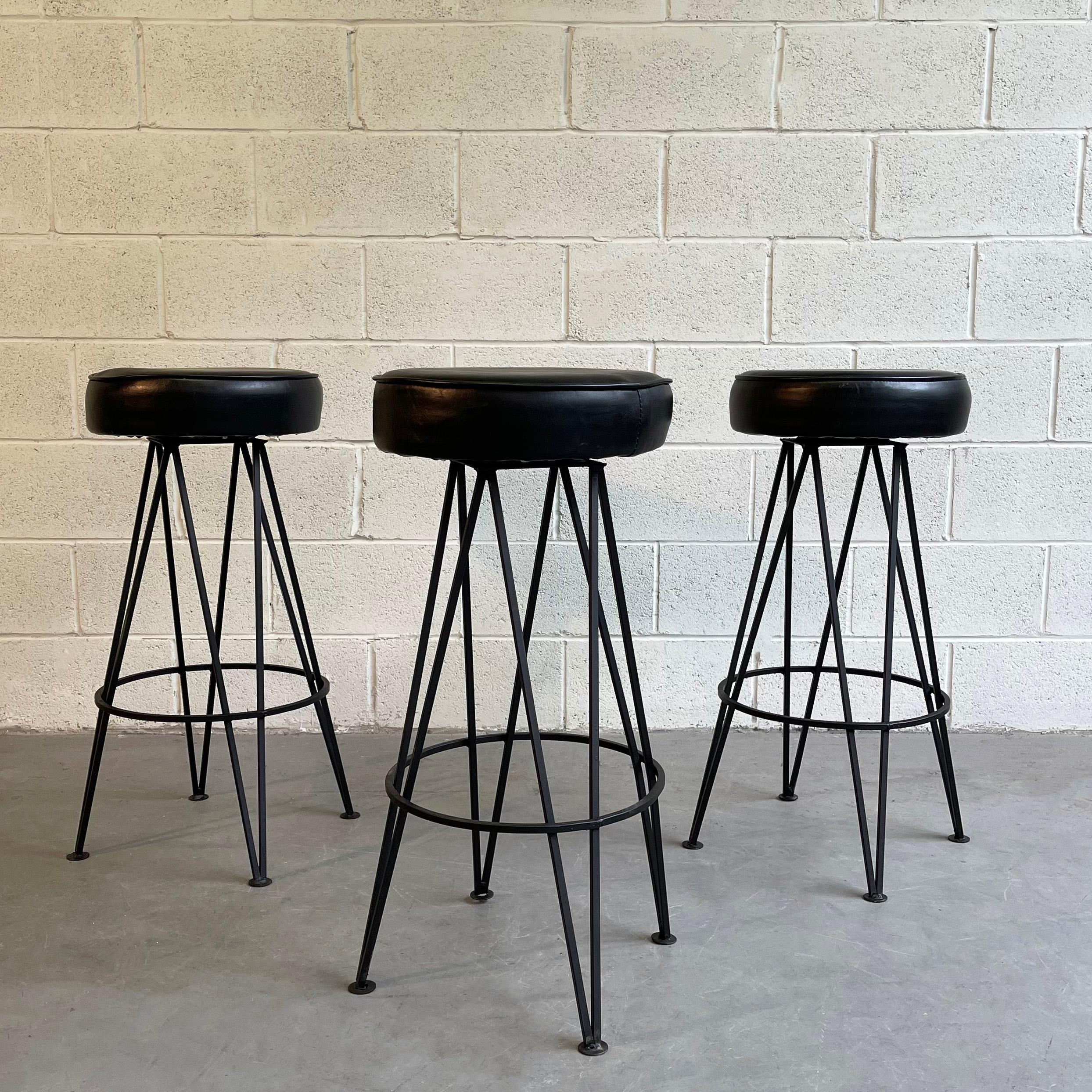 Set of 3, Mid-Century Modern, bar stools feature hairpin, wrought iron bases with 14.5 inch diameter vinyl seats.