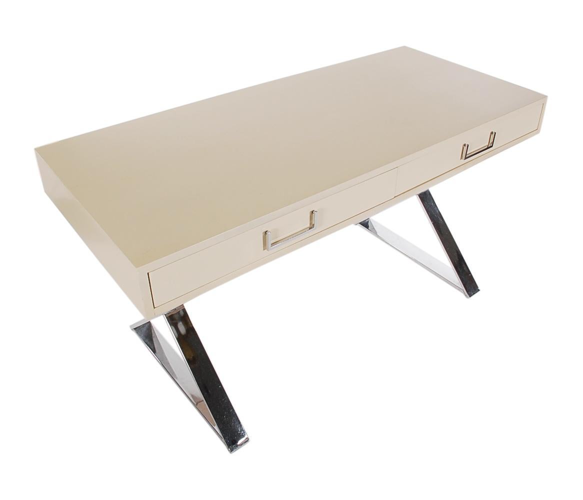 A beautiful vintage desk design by Milo Baughman and produced by Thayer Coggin in the 1970s. This desk features chrome scissor leg design with off-white lacquered top with two drawers. Very well cared for through the years. Ready for use.
