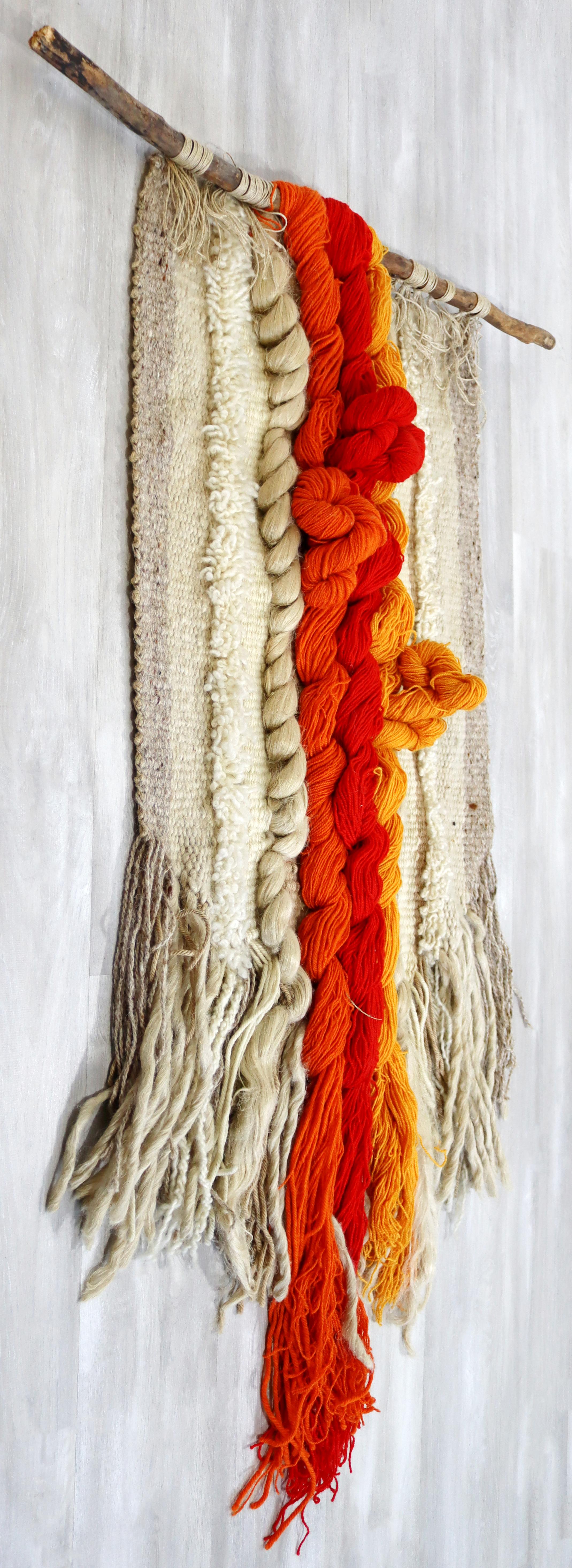 For your consideration is an incredibly fabulous, wool yarn fiber art wall sculpture, hung by a wooden stick, circa the 1970s. In excellent vintage condition. The dimensions are 36