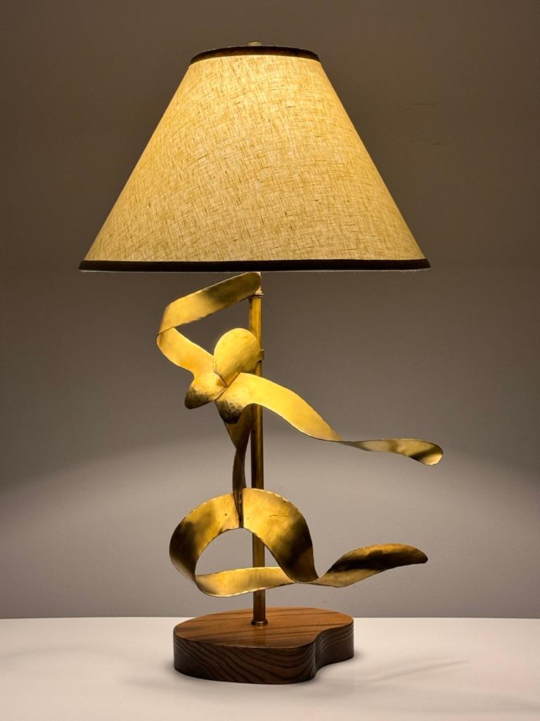 Uncommon table lamp designed by Yasha Heifetz 
Manufactured by Heifetz Manufacturing New York circa 1950s

Abstract hammered brass figure on biomorphic oak base
Finished with a new ivory linen shade 

Signed to base

30 inch height
13 inch base