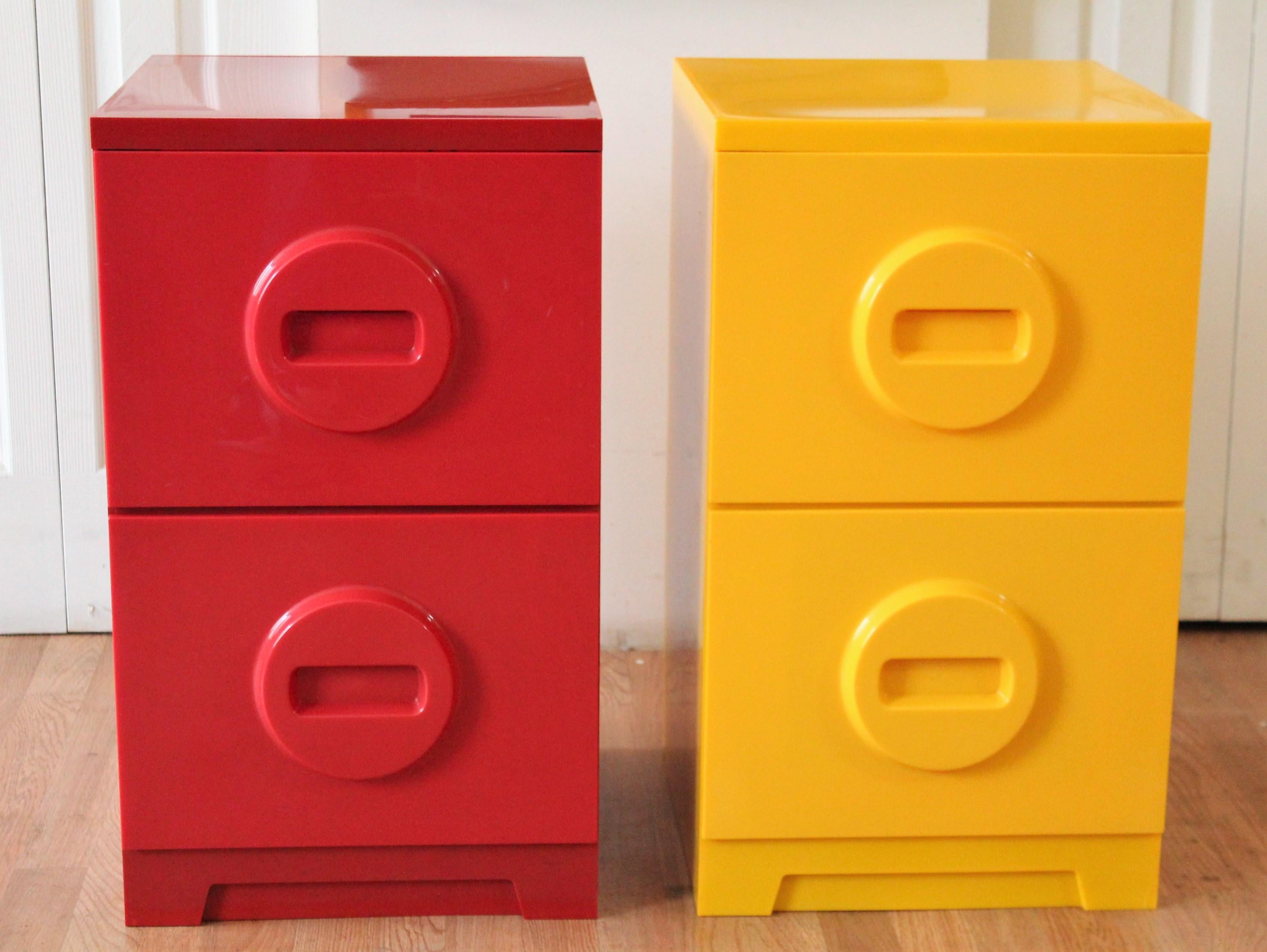 File in style with a 1970s Akro-Mils plastic filing cabinet in bright yellow and a deep red. Two drawers with a cool Lego-esque handle on each.