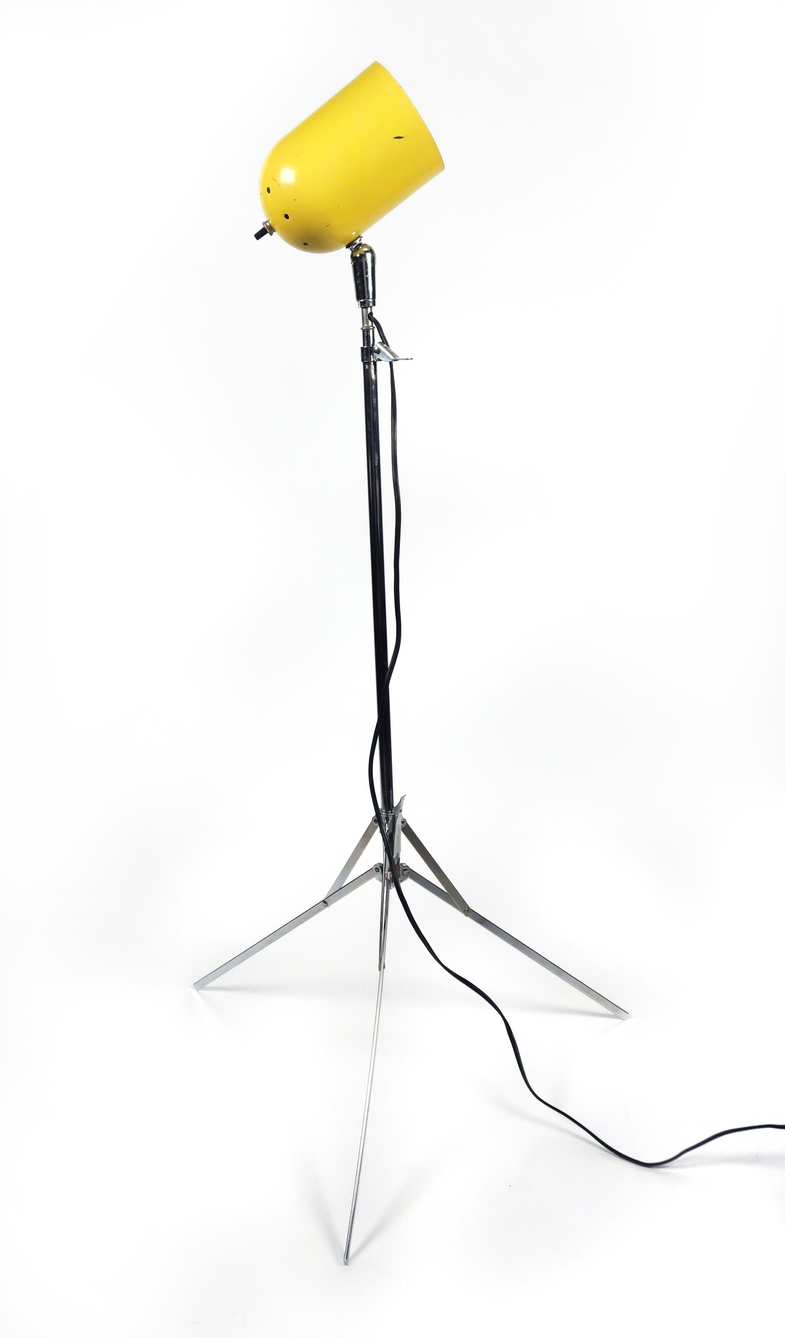 A vintage adjustable tripod base floor lamp with chrome base and stem and yellow metal shade. Height adjusts from 41” to 57” tall and base can be folded up for easy transportation. Works great as a reading or task lamp or for accent lighting. 

In