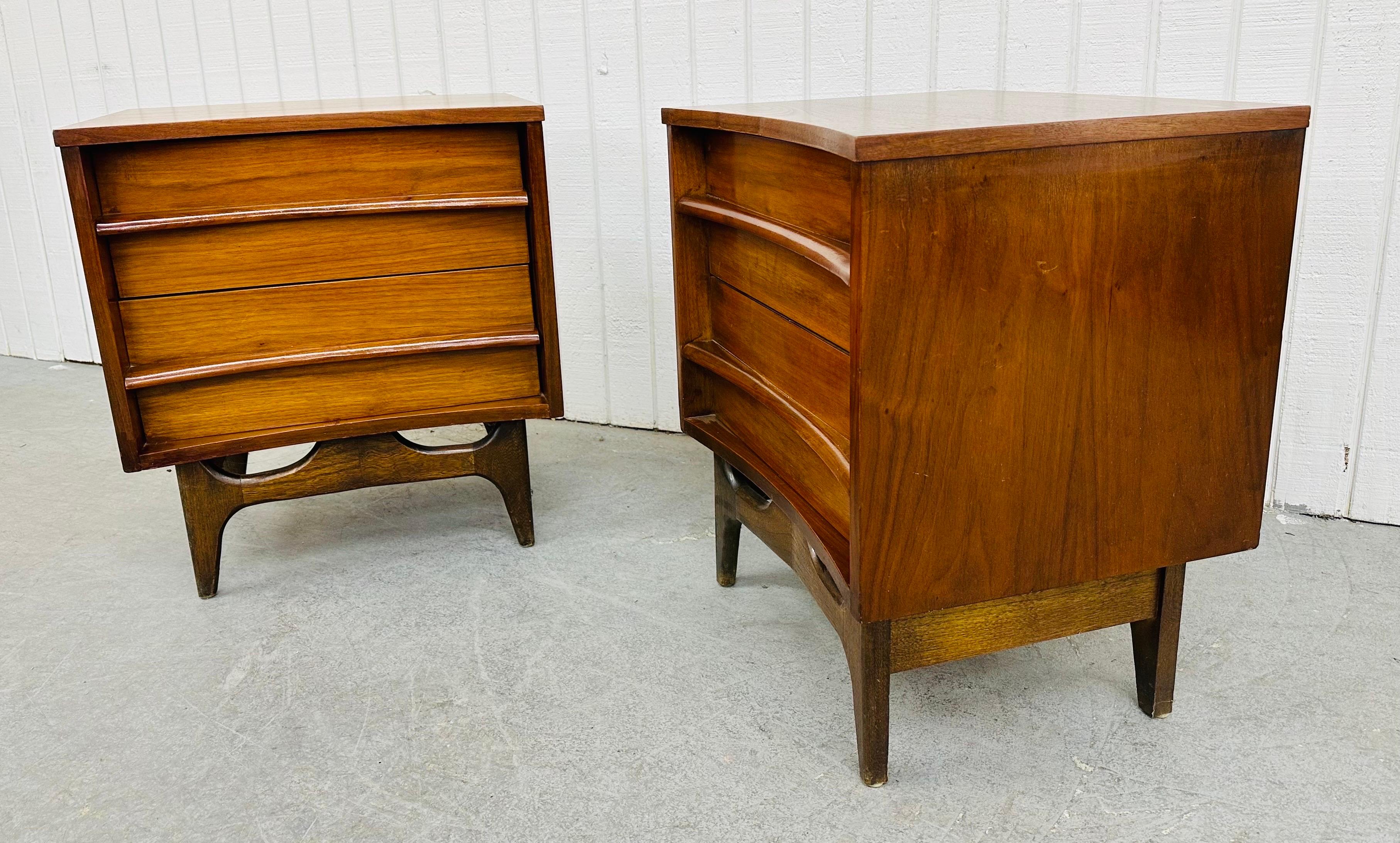 This listing is for a pair of Mid-Century Modern Young Manufacturing Walnut Nightstands. Featuring a curved front design, modern legs with sculpted stretcher, two drawers with wooden pulls, and a beautiful walnut finish. This is an exceptional