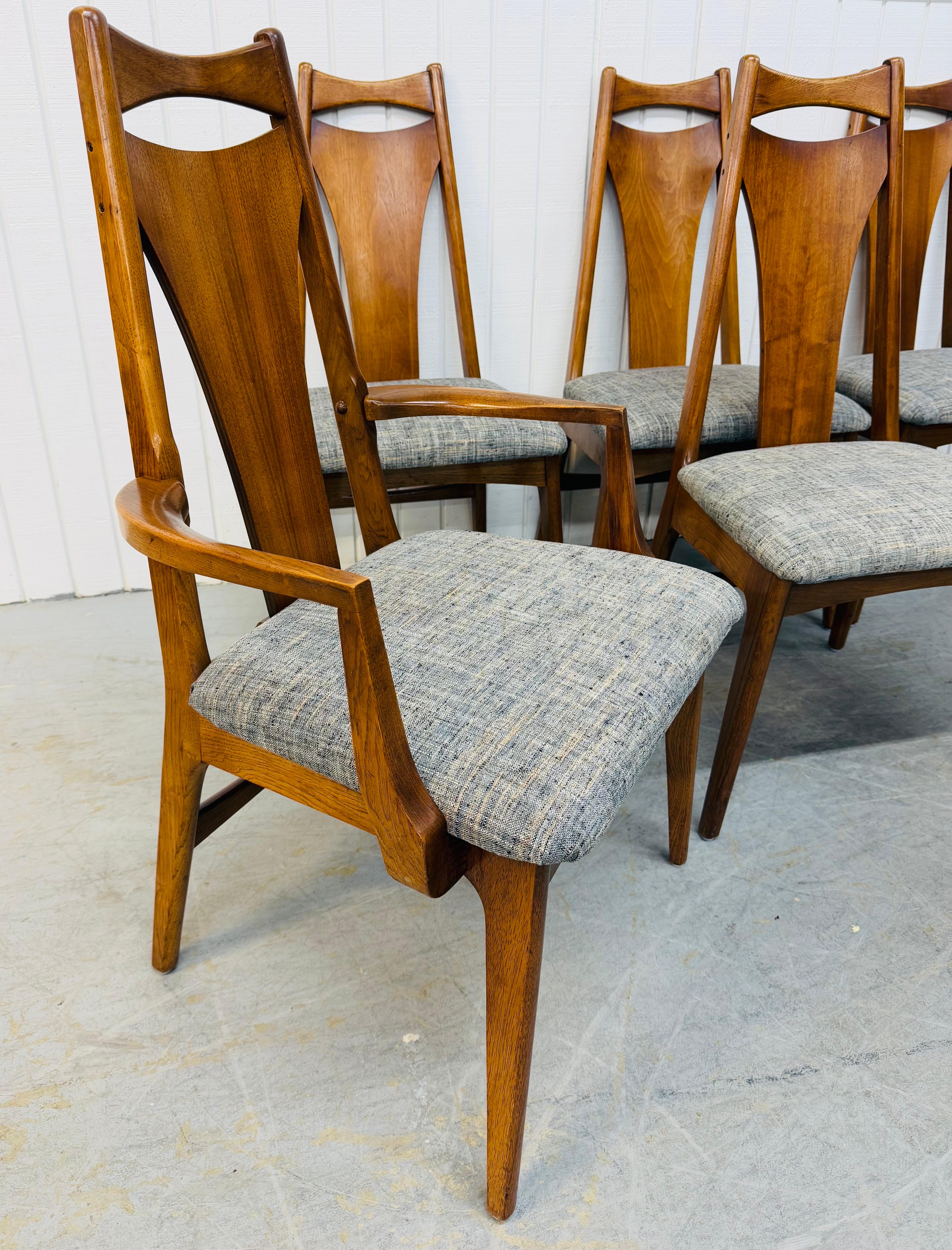 This listing is for a set of six Mid-Century Modern Young Manufacturing Walnut Dining Chairs. Featuring two arm chairs, four side chairs, wooden back rests, new upholstered seats, modern legs, and a beautiful walnut finish. This is an exceptional