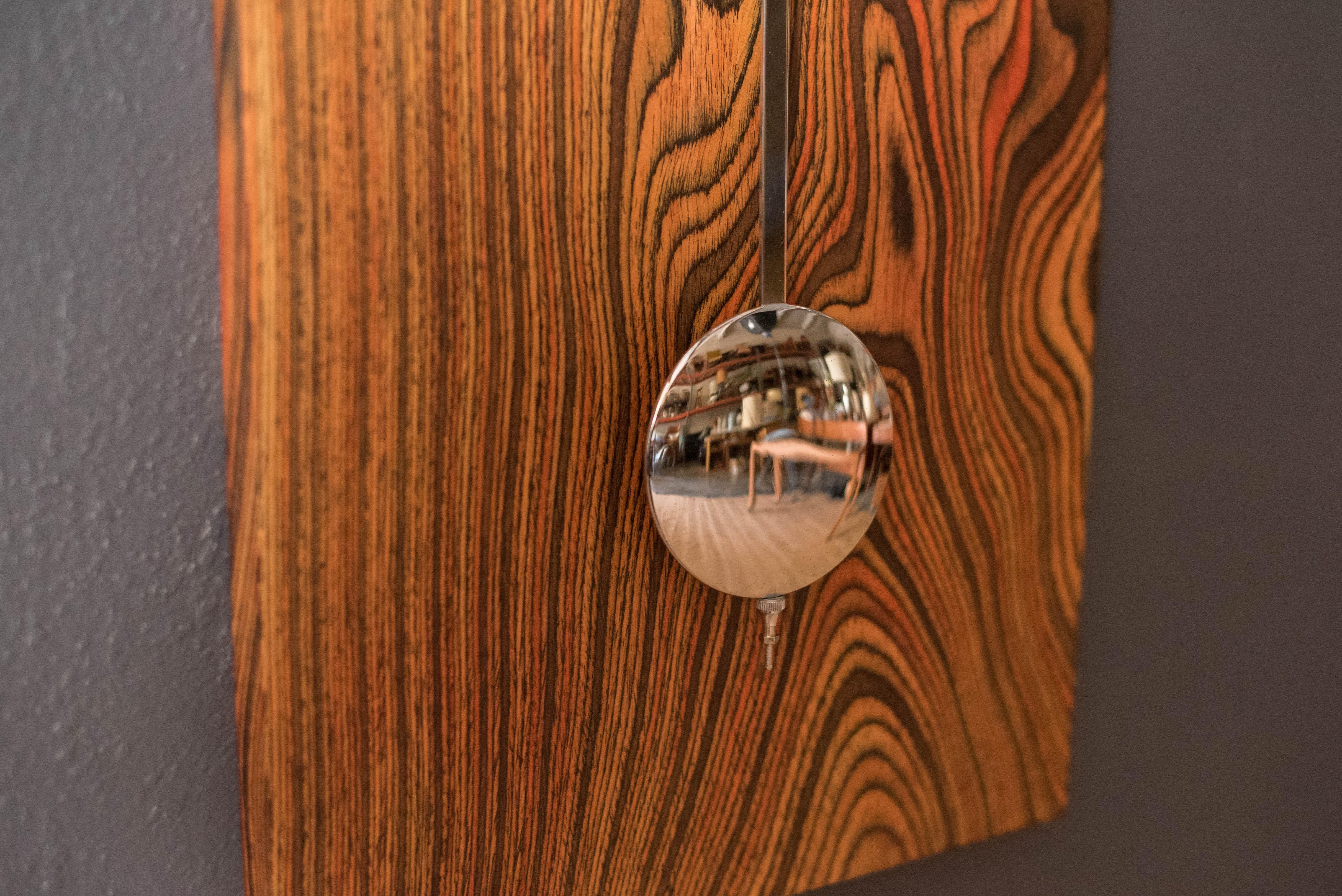 Polished Mid Century Modern Zebrawood and Chrome Wall Clock by Howard Miller For Sale