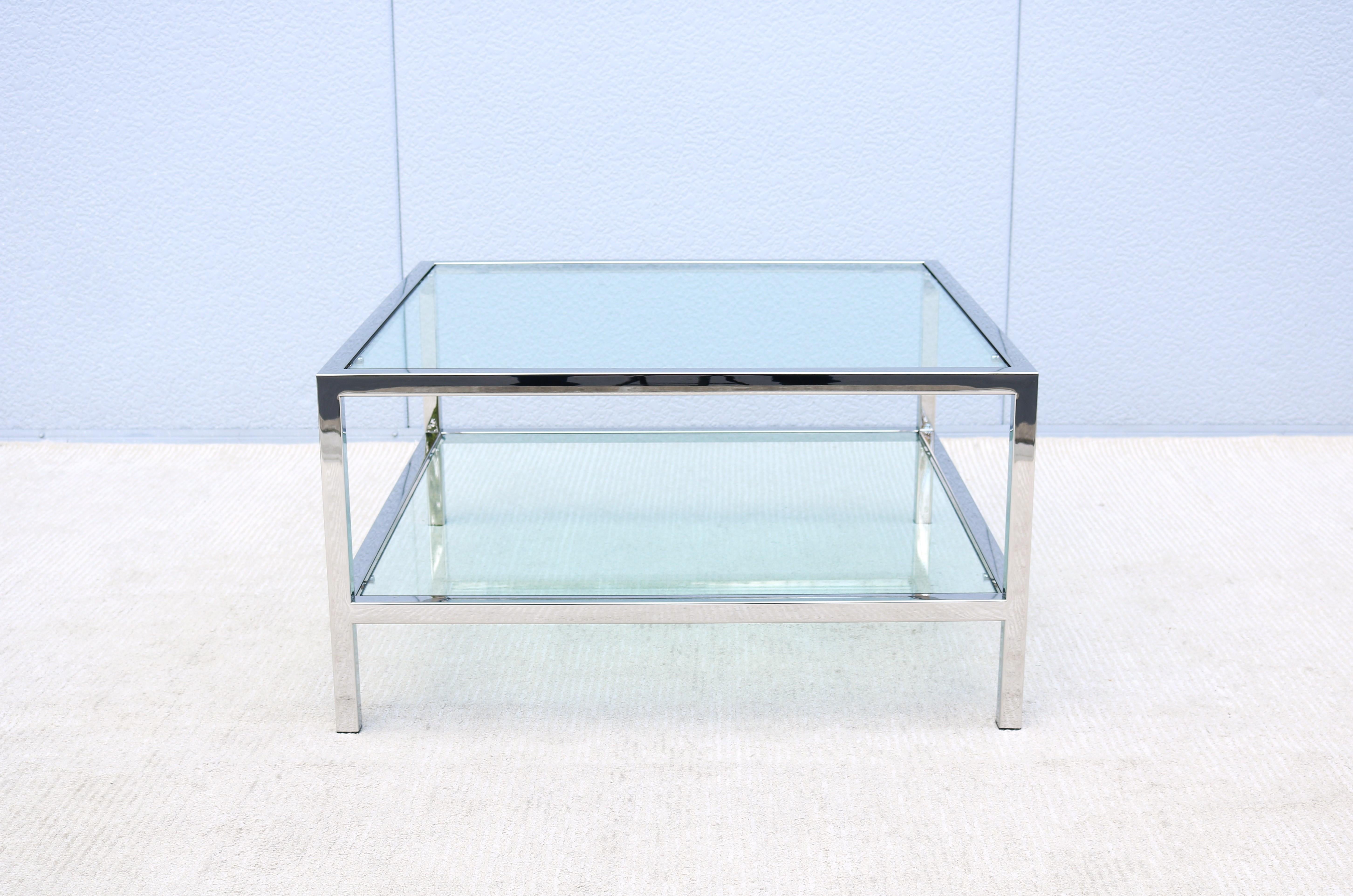 Stunning and elegant looking mid-century modern Milo Baughman style polished stainless steel and inset glass top square coffee table.
Features a lower open glass shelf, that adds a perfect spot for books, a basket, or other personal items.
This