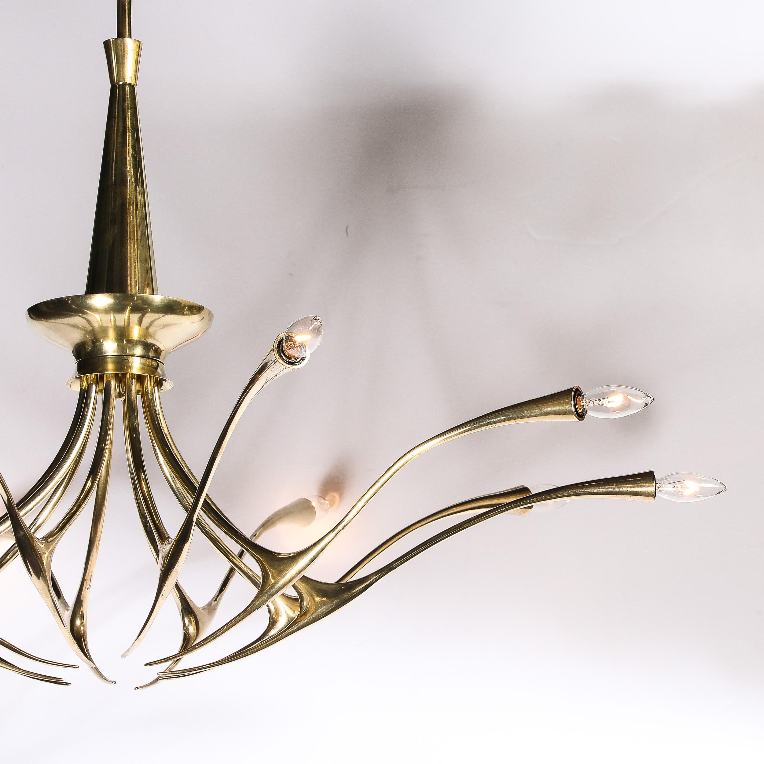 This dynamic and elegant Mid-Century Modernist 10 Arm Sculptural Brass Chandelier is designed by Oscar Torlasco for the company Lumi and originates from Italy, Circa 1955. Features a brilliant composition of ten equidistantly spaced sculptural arms,