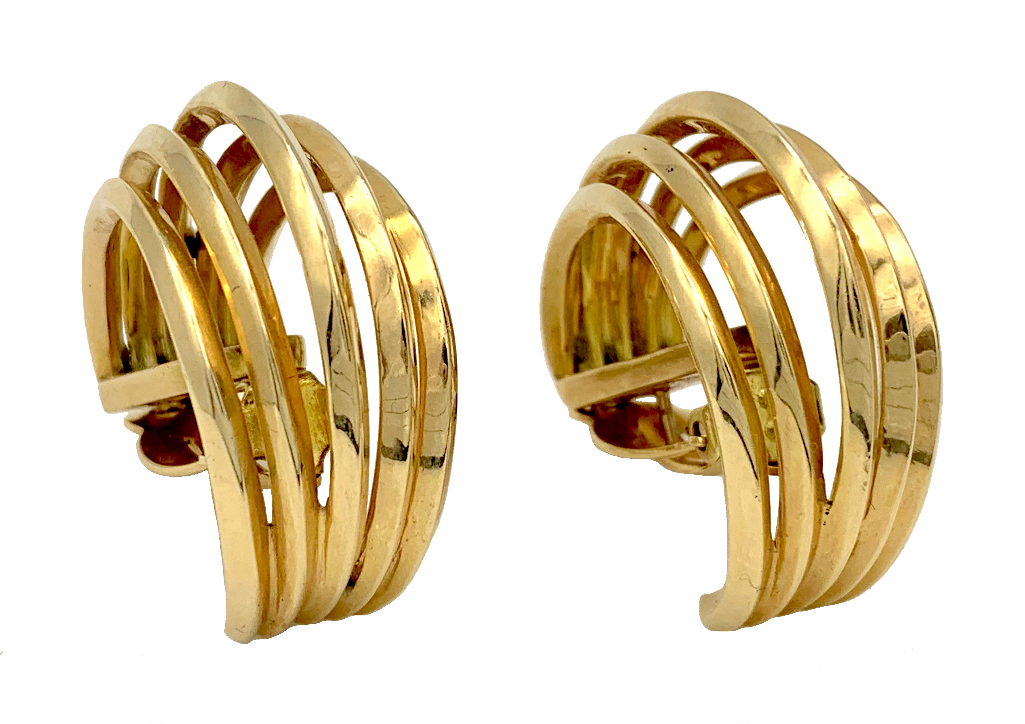 These substantial clip- on- earrings are made out of 14 karat gold and are designed as five three quarter hoops.