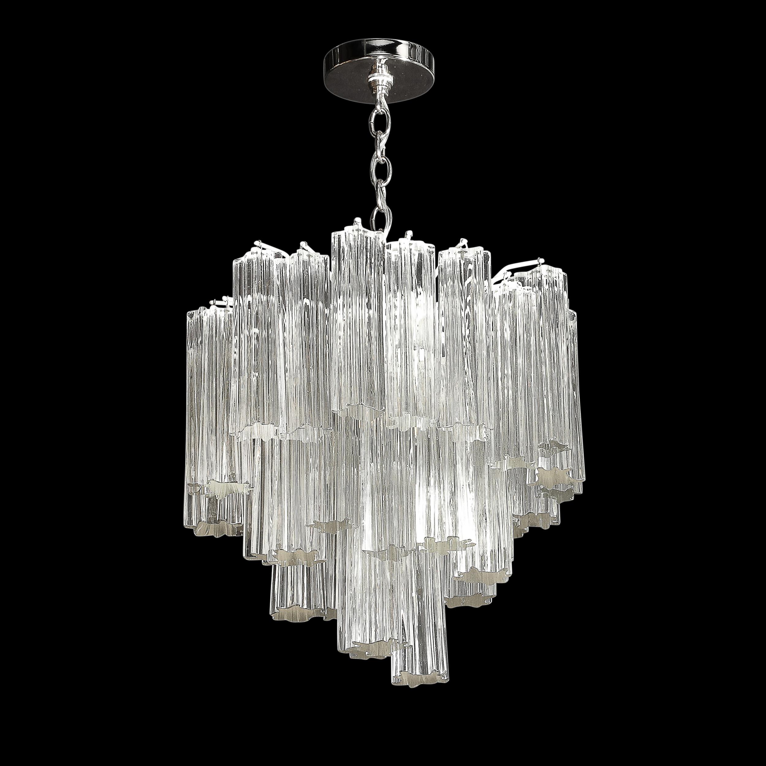 This rare and highly unique Mid-Century Modernist Three Tier Solid Tronchi Hand-Blown Murano Glass Chandelier W/Nickel Fittings originates from Italy, Circa 1970. A gorgeous piece rendered in transparent glass, each element is formed in solid