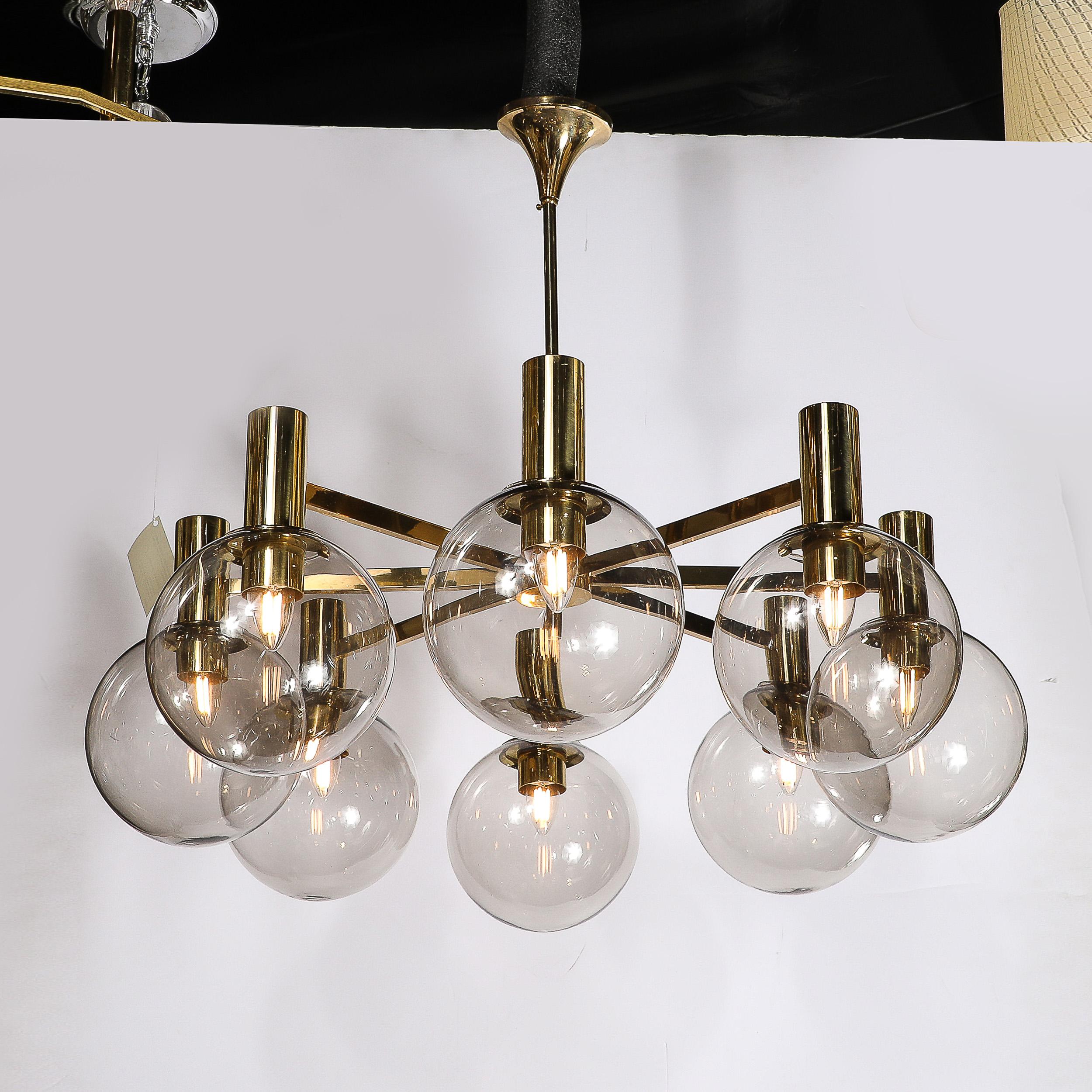 This expansive and beautifully proportioned Mid-Century Modernist Eight Globe Chandelier in Polished Brass is by the esteemed designer Hans Agne Jakobsson originates from Sweden, Circa 1960. Features a sleek geometric frame in gleaming polished