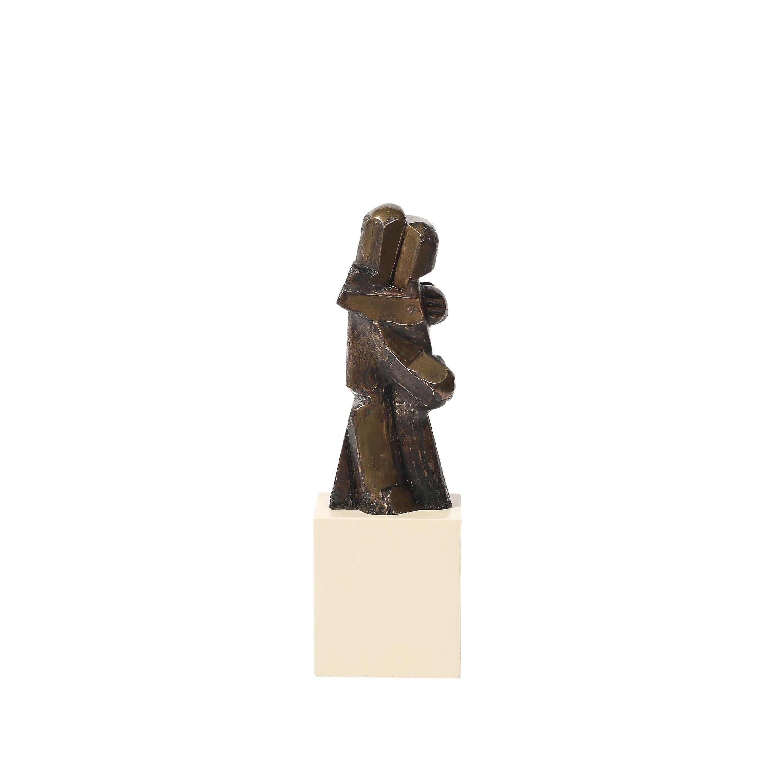 This evocative Mid-Century Modernist bronze sculpture, crafted in America circa 1950, represents an abstracted figural depiction of an embracing couple. Boldly minimalist and deeply expressive, the piece captures the essence of human connection in