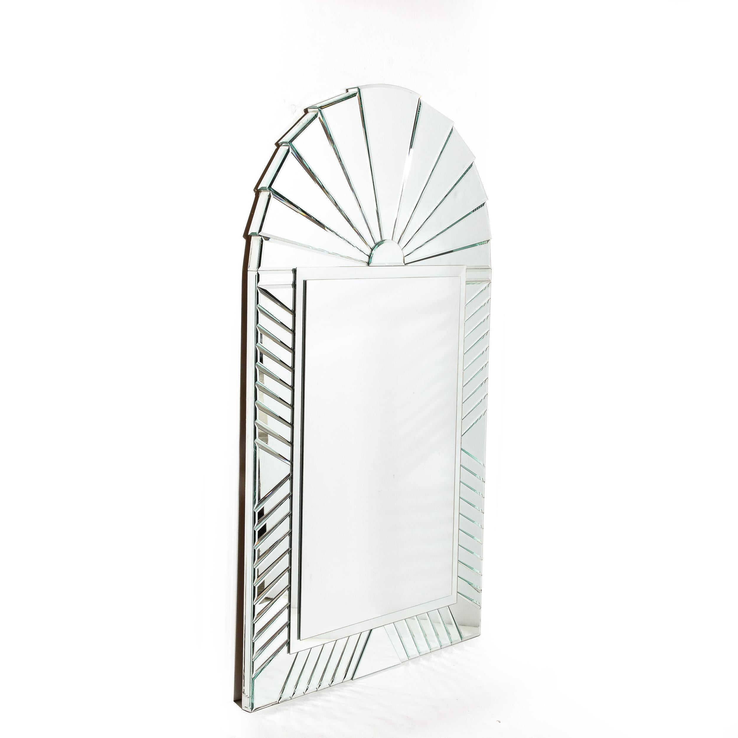 This striking Mid-Century Modernist Arch form Mirror originates from the United States, Circa 1970. Composed of an array of beveled mirror glass sections expanding beautifully and surrounding the central panel, the varied dimensions and proportions