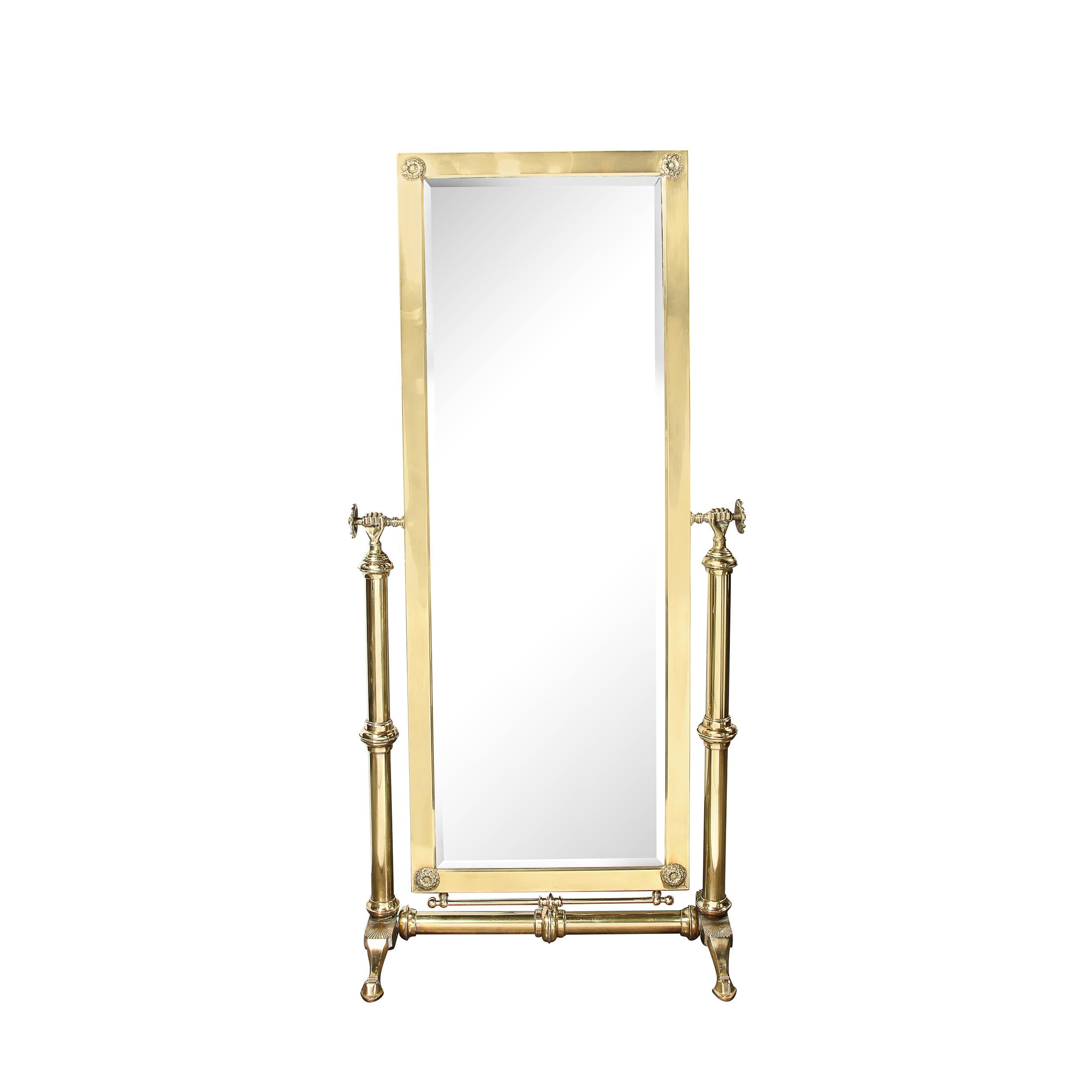 This bold and well adorned Mid-Century Modernist Articulating Cheval Mirror in Brass originates from the United States, Circa 1960. Featuring a vertical rectilinear profile in solid brass, this piece is supported by a highly stylized base drawing on