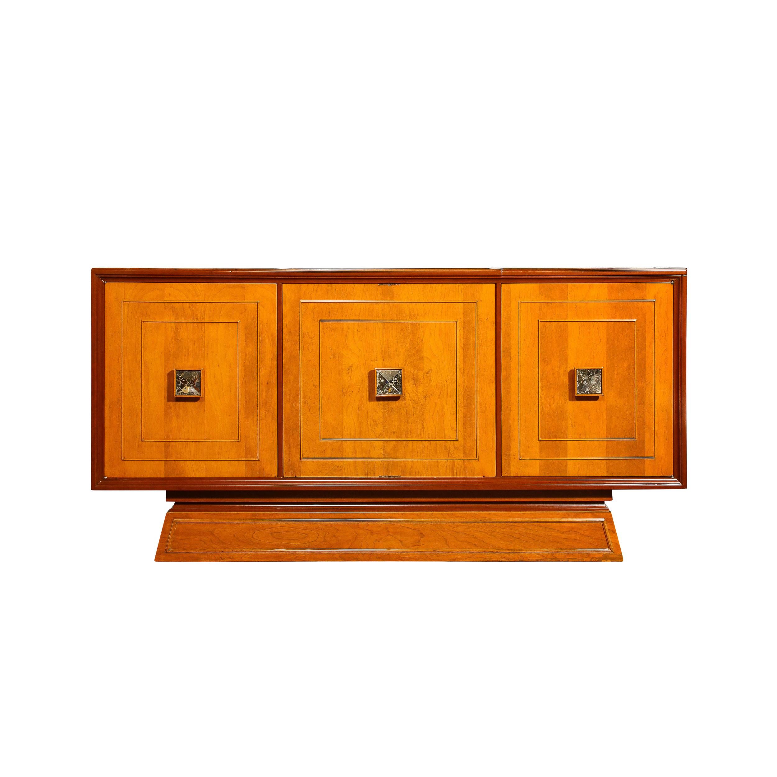 This stunningly bold and sophisticated Mid-Century Modernist Bar Cabinet in Bookmatched Walnut with Inset Antiqued mirrored Glass Pulls originates from France, Circa 1950. Features a rectilinear geometric design composed of three square sections