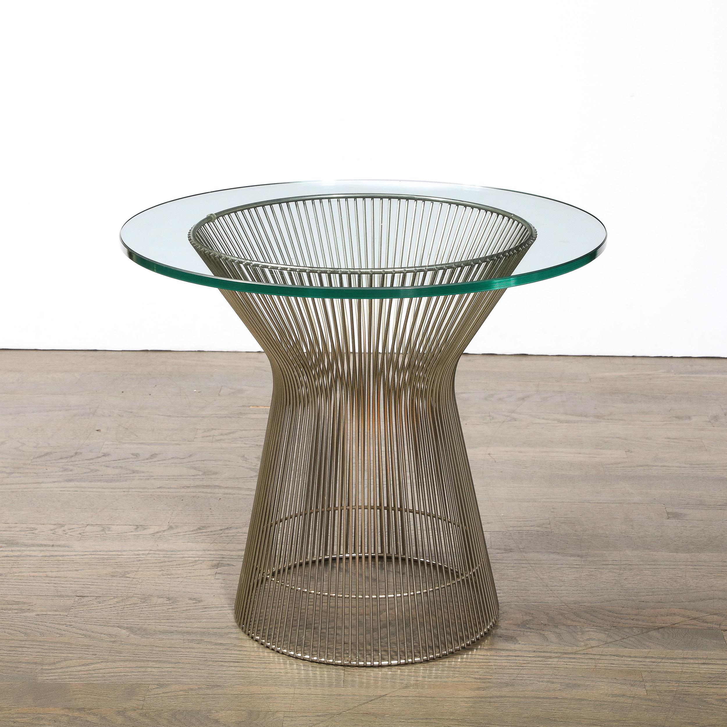 This Bent and Polished Nickel side Table designed by Warren Platner originates from the United States, Circa 1970. Featuring an hourglass form in a series of parallel nickel cylinders, the geometric minimalist construction is characteristic of