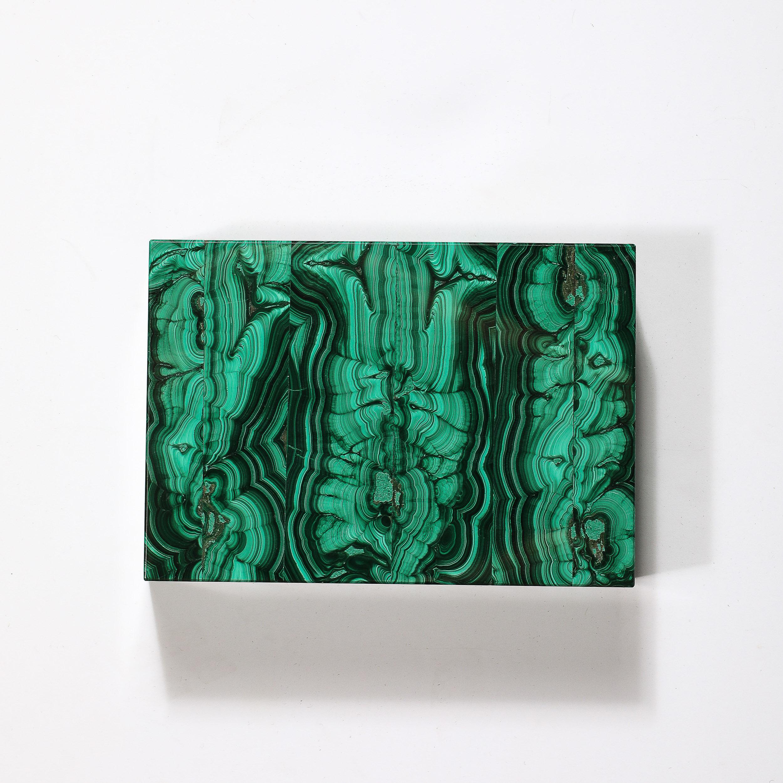 This stunning Mid-Century Modernist Bookmatched Malachite Box originates from Russia, Circa 1970. Featuring a lovely textural surface composed of book-matched malachite, the material variation continues throughout the surfaces of the piece with