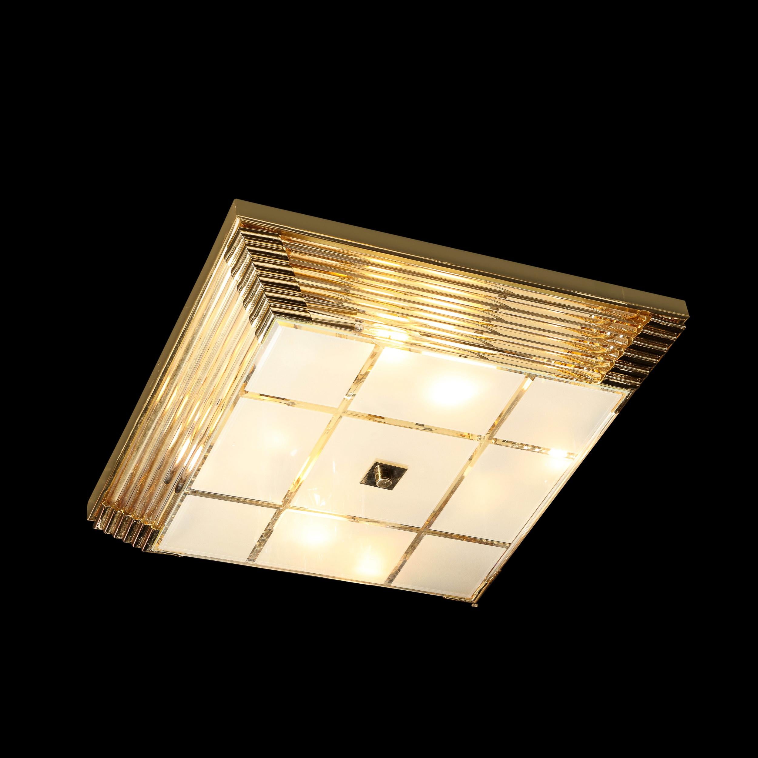This Mid-Century Modernist square brass and glass rod flush mount chandelier originates from Italy Circa 1970. This flush mount chandelier features a stepped designed square shape that is composed of horizontally staggered glass rods that are