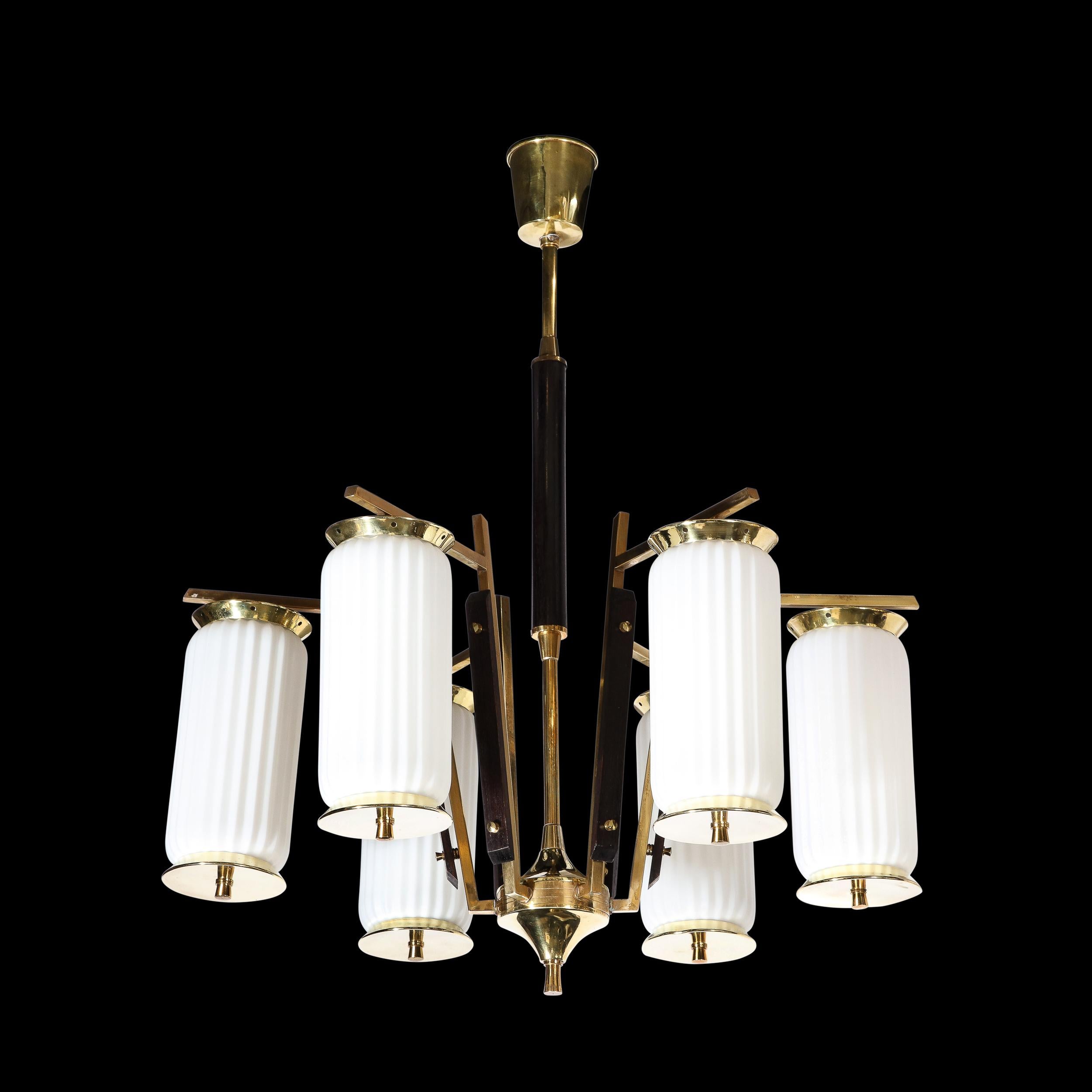 This handsome Mid-Century Modernist Brass, Striated Glass & Ebonized Walnut Six Arm Chandelier originates from France circa 1960. A stunning gem of material variation with impeccable construction and design, this fixture features six striated