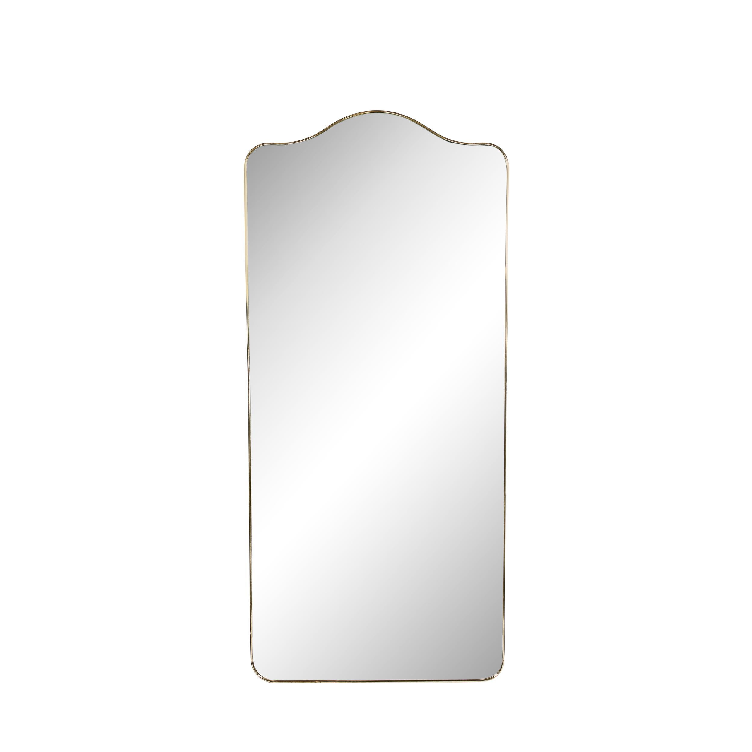 This elegant Mid Century Modern Brass Wrapped Mirror W/Rounded Arch Motif was realized in Italy, circa 1950. It offers a rectangular form with rounded corners and a subtle arch form motif top wrapped in lustrous brass, while the interior is plain