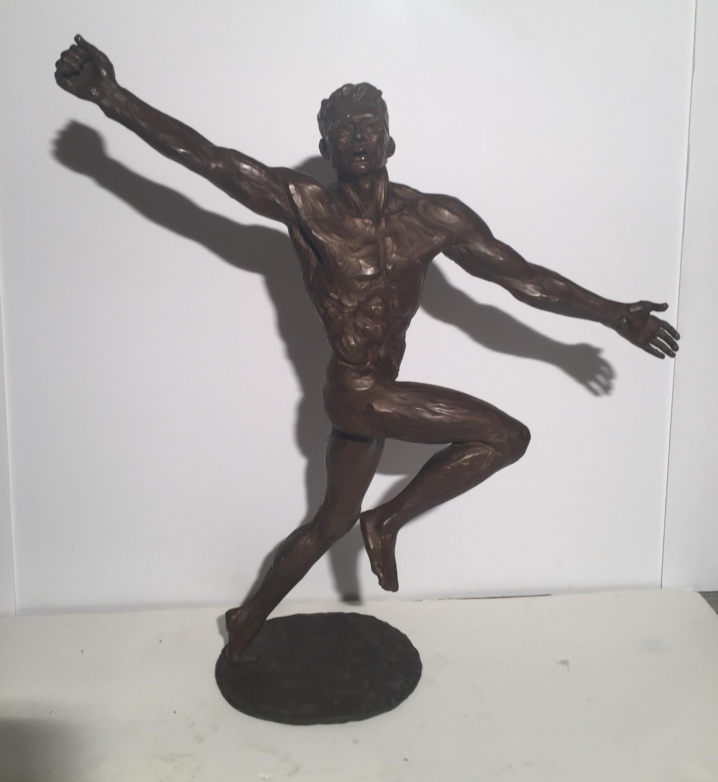 A powerful modernist bronze sculpture of an Athletic male nude signed at base John Jones. The figure with raised arm and running stance on a circular signed bronze base.