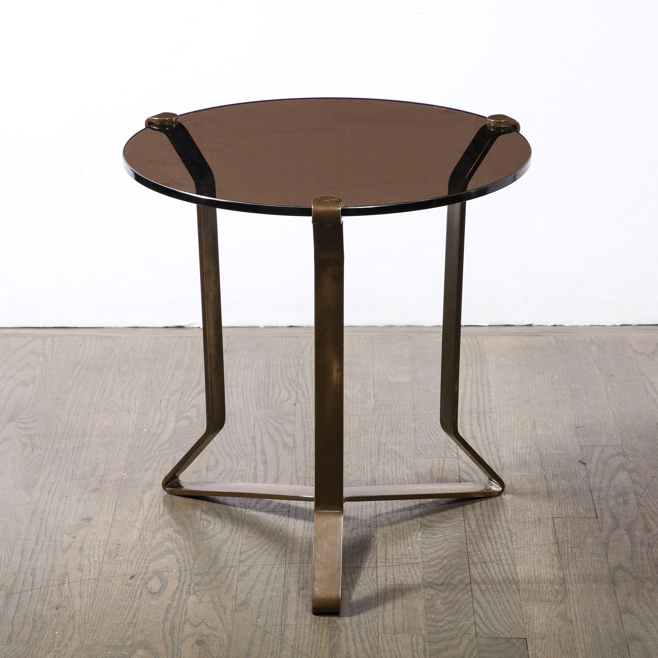 This dynamic yet reserved Mid-Century Modernist Bronze and Smoked Glass Side / Occasional Table originates from the United States, Circa 1950. Features supports and base composed of a minimal framework in oil rubbed bronze, elegantly formed and