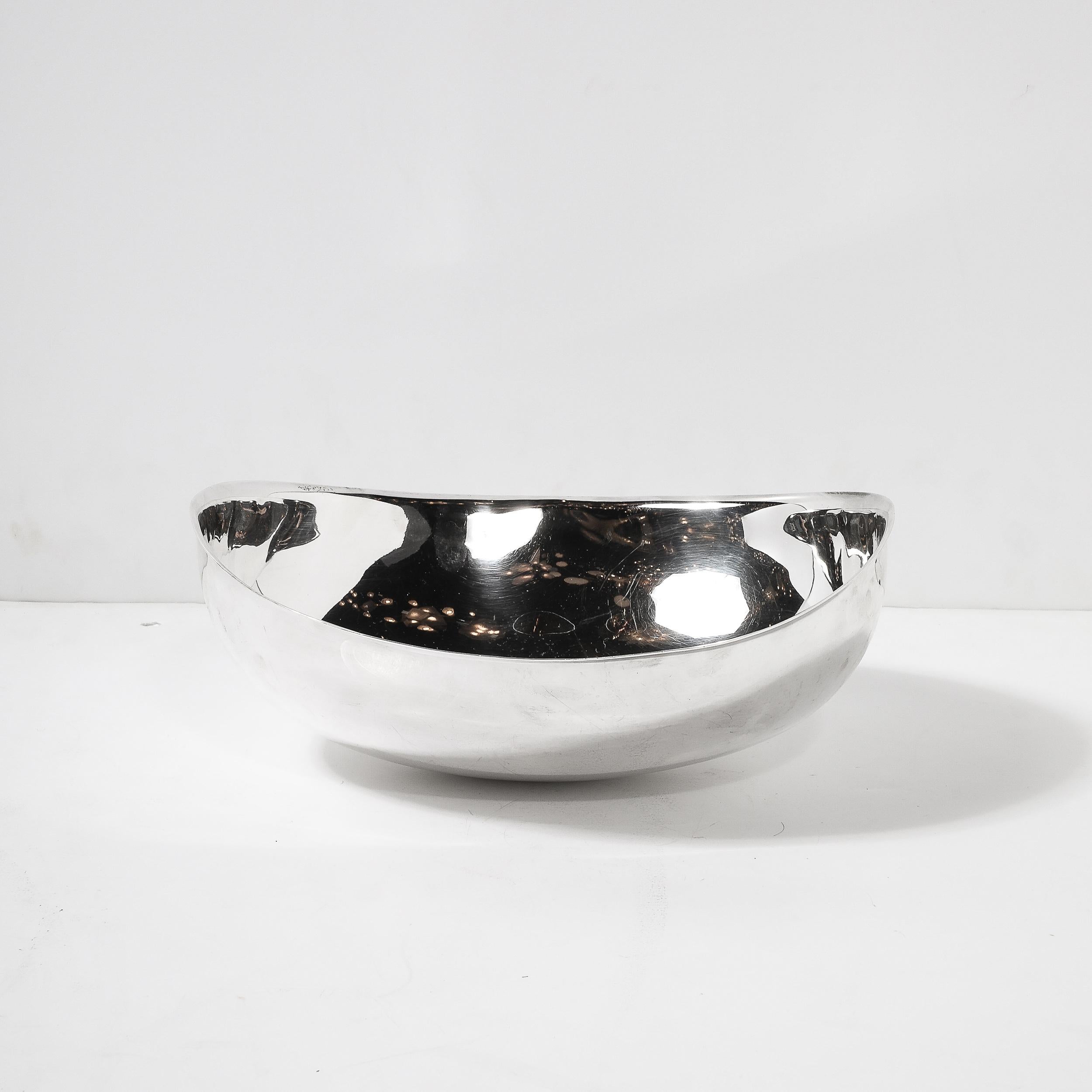 This striking mid-century modernist 'Candara' centerpiece bowl, circa 1970, is signed by the renowned Italian designer Sabattini. It stands as a testament to the era's commitment to elegance and innovation, with a stunning silver-plated finish that