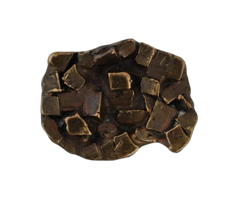 A mid-20th century cast bronze pin brooch. Modernist geometrical design. Hand-etched inscription on the backside: Now Is the Time for All Good Men, JW. The phrase refers to a 1967 Broadway musical by Nancy Ford and Gretchen Cryer. Unusual Designer