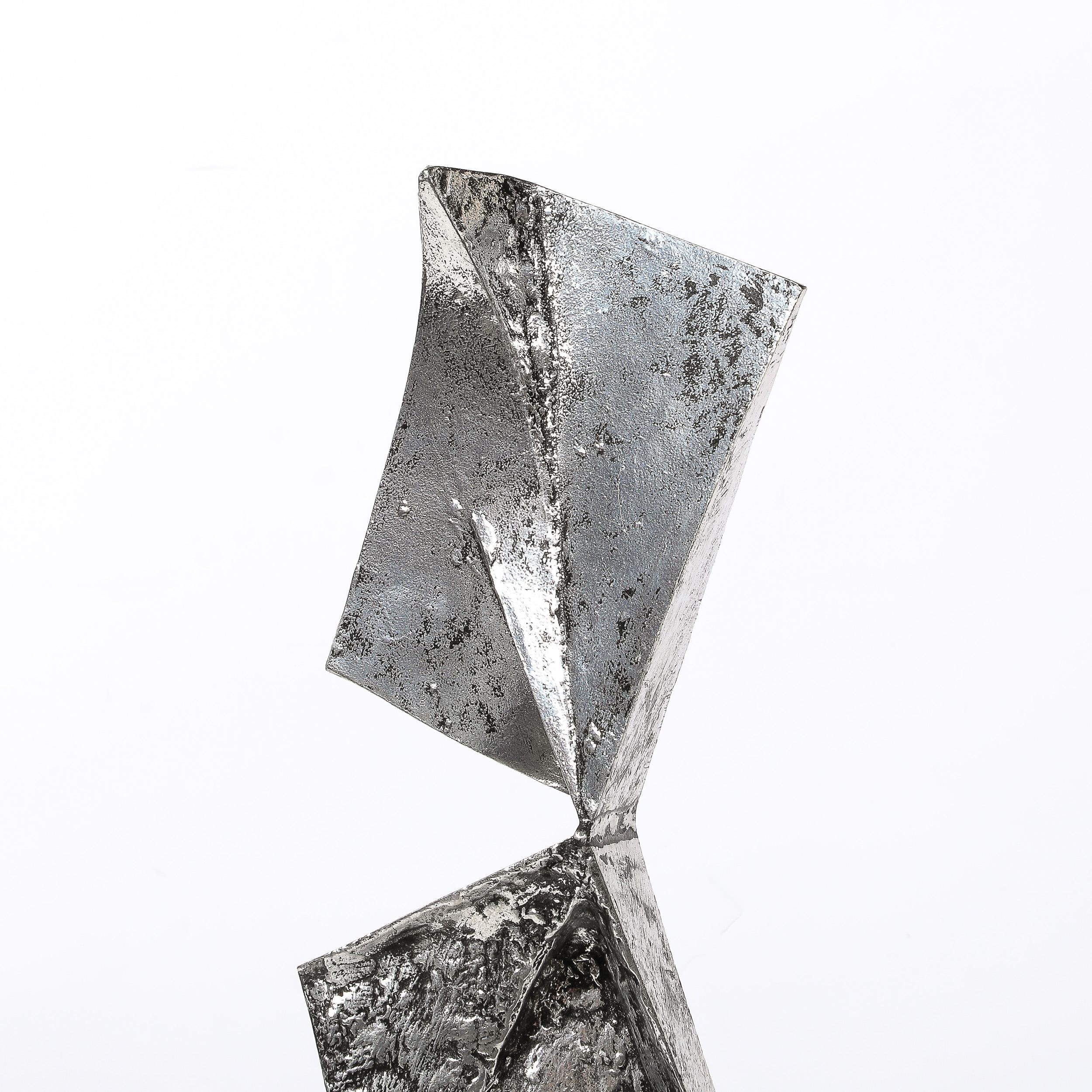 This sharp and angular Mid-Century Modernist Abstract Geometric Sculpture in Cast and Welded Aluminum by Arthur Court originates from the United States, Circa 1975. Features a vertical composition in abstracted triangular forms, joined at their