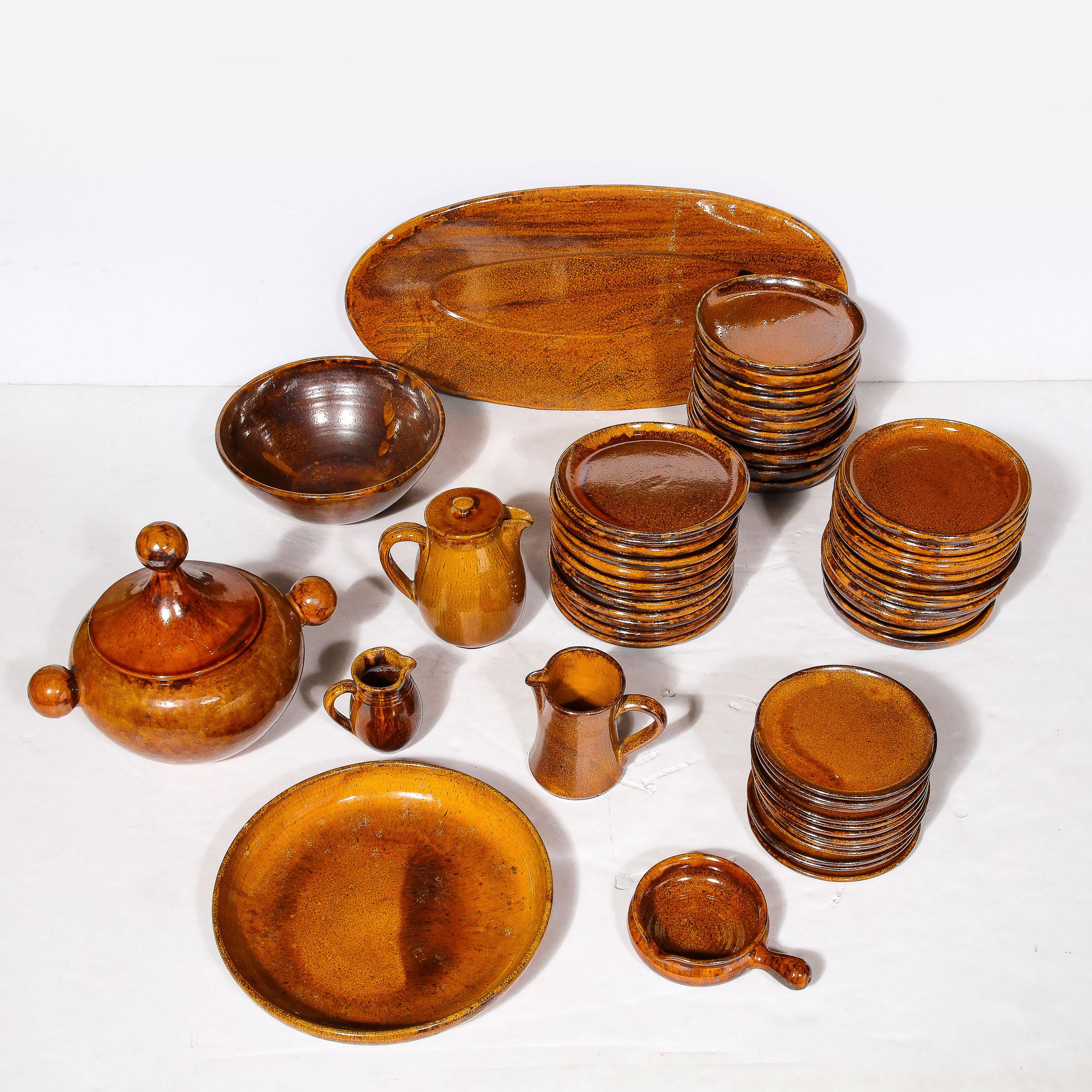 This rare and stunning Mid-Century Modernist Serveware Set for twelve by Vieux Biot originates from France, Circa 1950. Featuring a large variety of pieces sufficient for large gatherings and complex meals, these pieces are hand-made in the