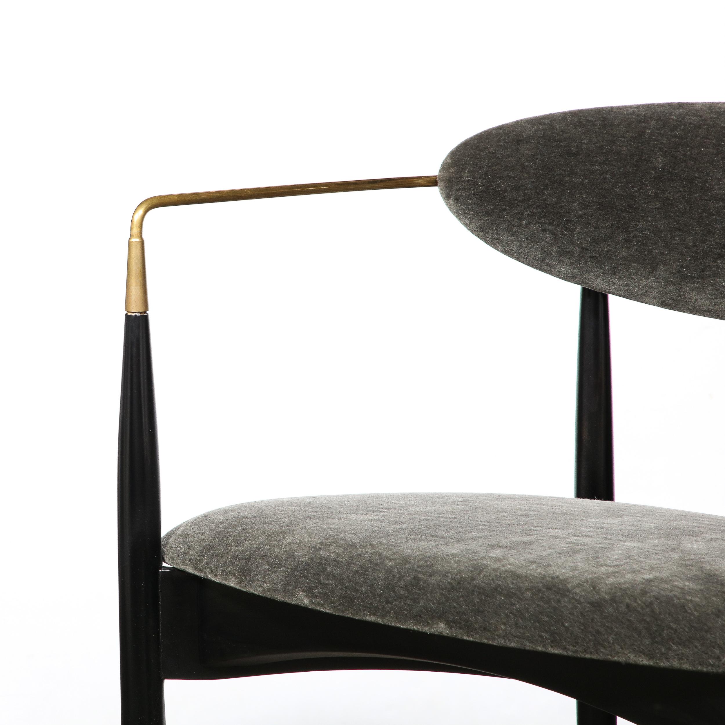 This Mid-Century Modernist Sculptural Chair in Black Enameled Walnut with Brass Arms is created by Kofod-Larsen and originates from Denmark, Circa 1960. Featuring a gorgeous open framework to the construction with an upholstered seat and back in