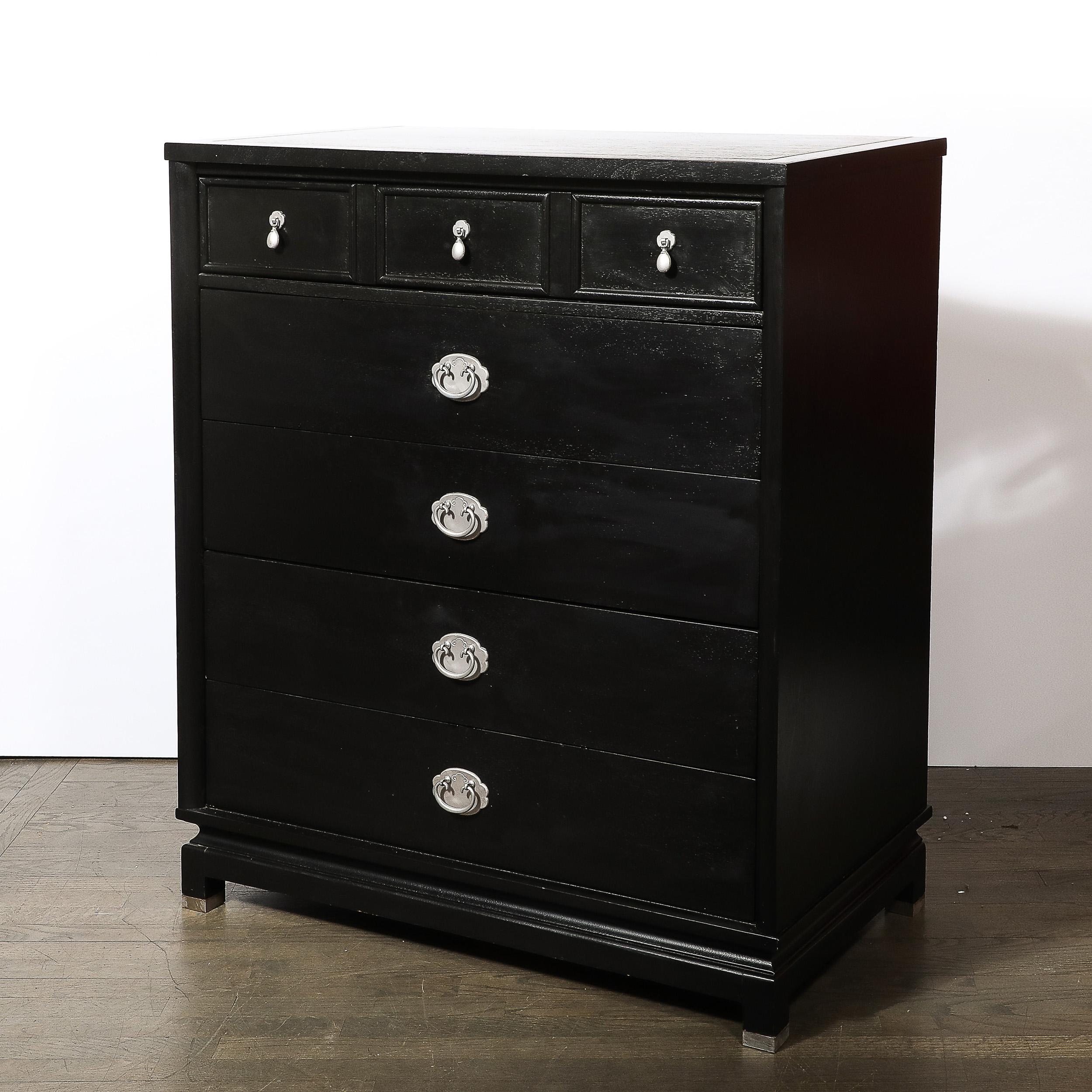 This substantial and reserved Mid-Century Modernist Chest of Drawers in Ebonized Walnut and Antique Nickel Hardware originates from the United States, Circa 1960. Features a plinth base with sabot detailing and beautifully subtle bevels and grooved