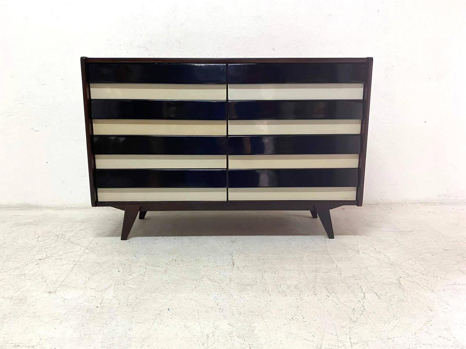 Modernist mahogany chest of drawers, model no. U-453, designed by Jirí Jiroutek for Interiér Praha. It was made in the former Czechoslovakia in the 1960s. This model is associated with the world-famous EXPO 58 in Brussels. It features dark stained