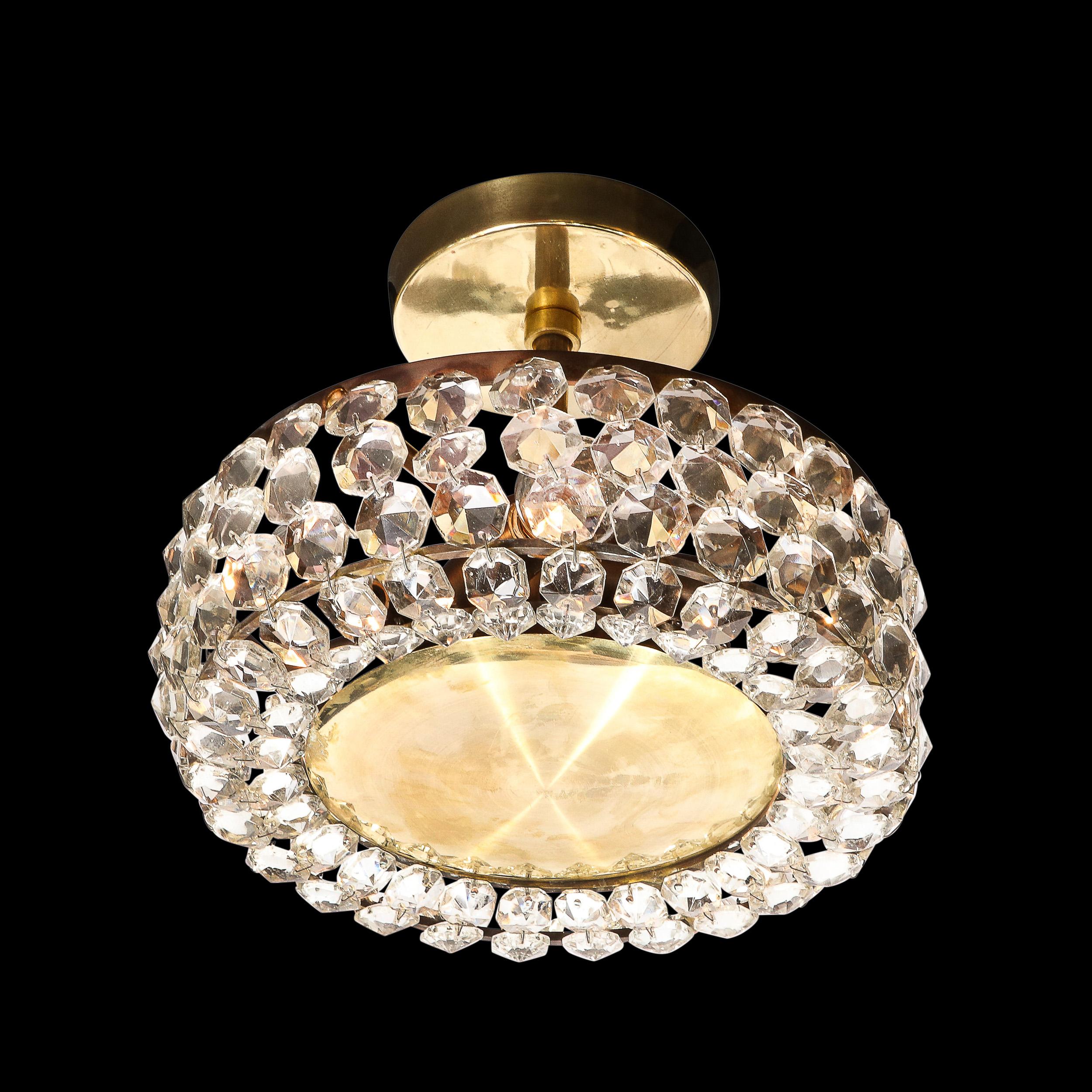 This Mid-Century Modernist Crystal and Brushed Brass Pendant Chandelier by Bakalowits and Sohne originates from Austria, Circa 1960. This pendant is a well adorned and charming fixture, featuring a polished brass canopy, rod, and frame supporting