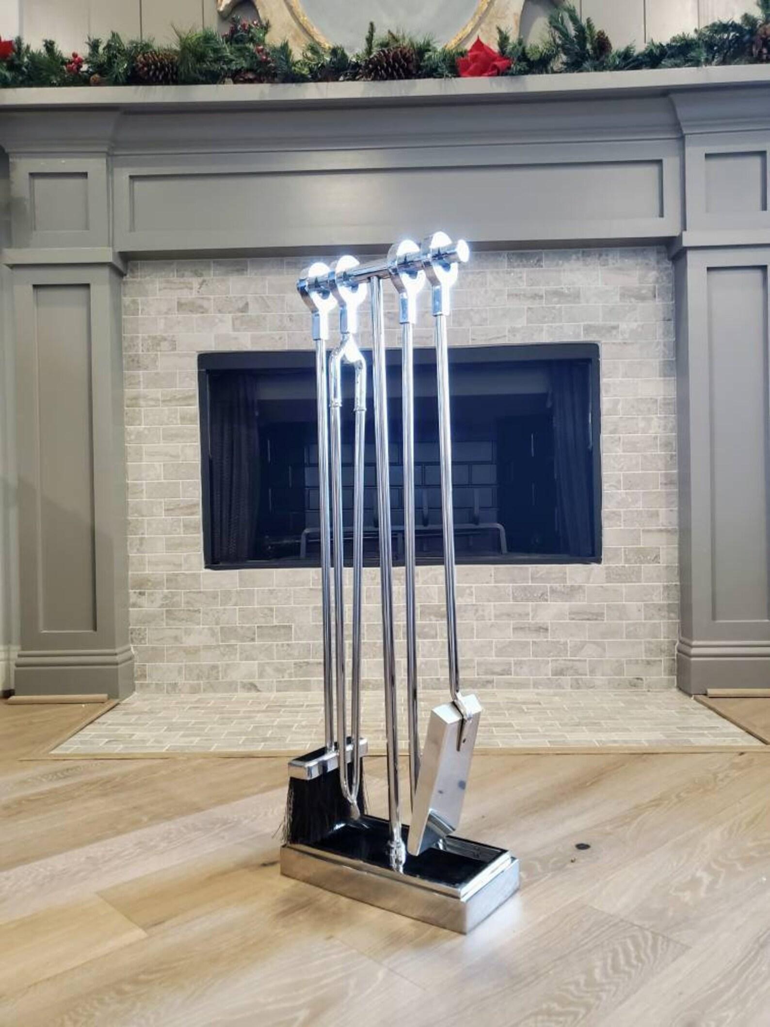 A stunning set of Post-Modern fireplace tools by Danny Alessandro. Bold, elegantly refined minimalist taste, artistic very fine quality cast fire tools with ring handles in chromed nickeled steel, comprising four implements each with a circular