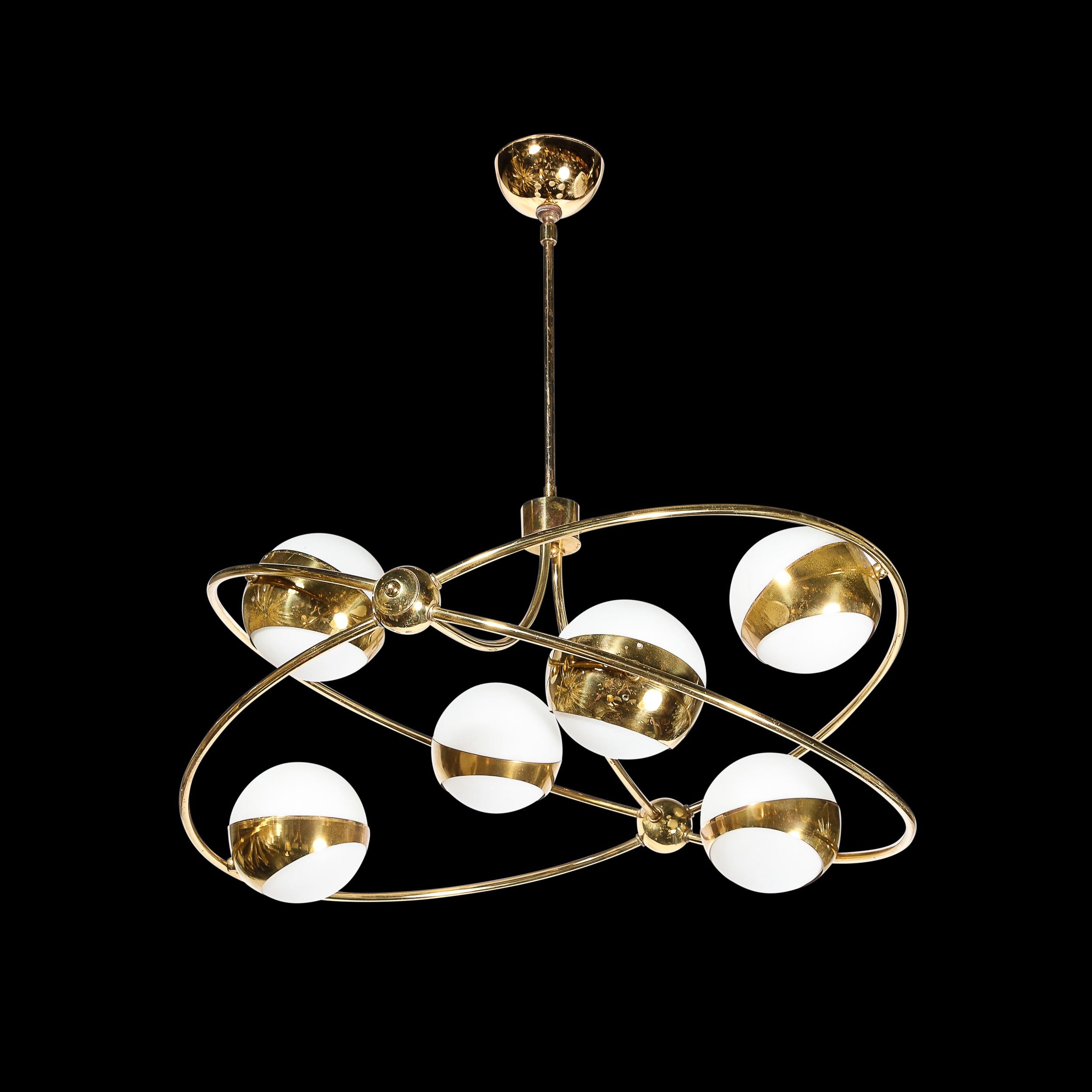 This unique and striking Mid-Century Modernist Elliptical Six Globe Chandelier in Brass and Frosted Glass was created by Stilnovo and originates from Italy, Circa 1950. Featuring a gleaming bass framework of two elliptical elements joined where they