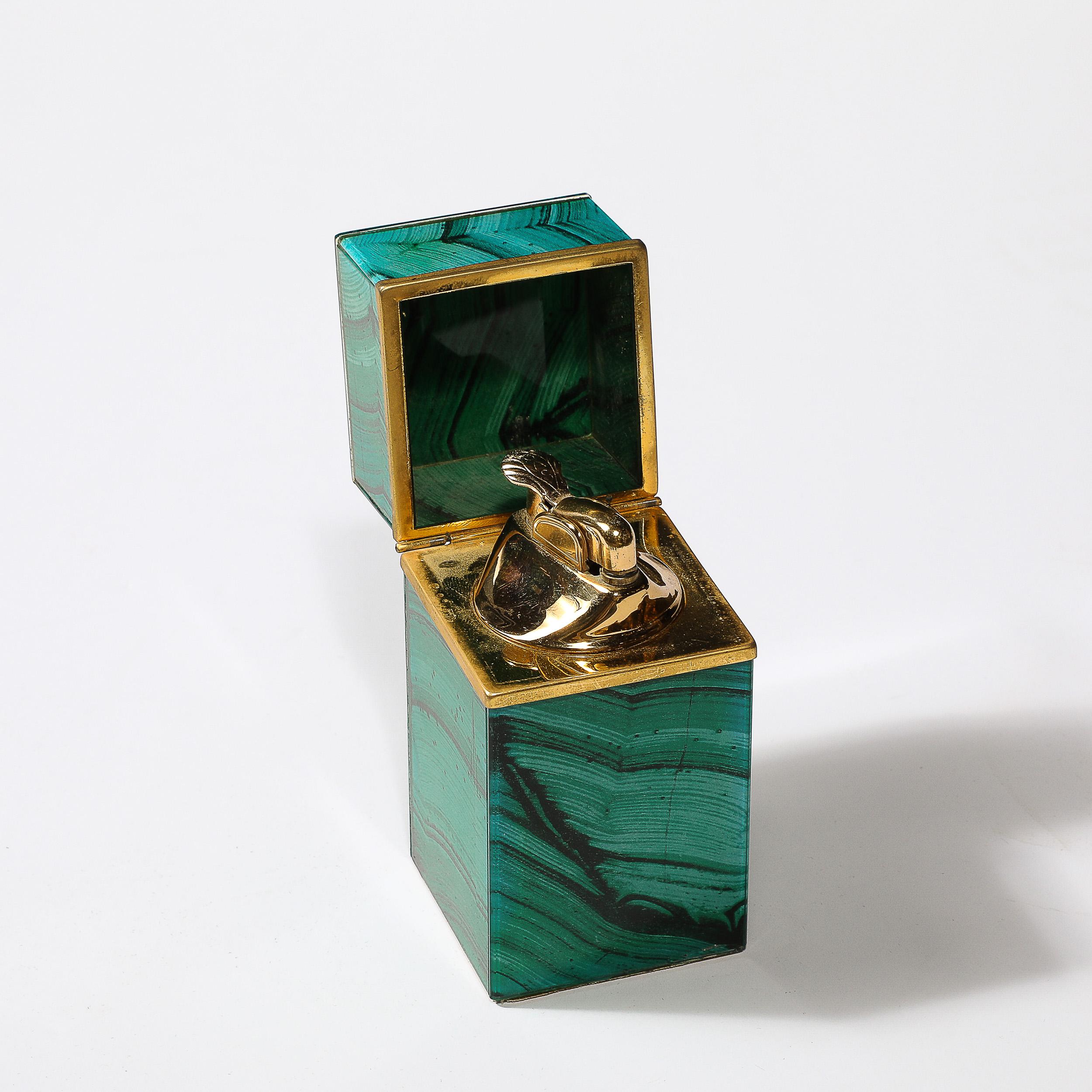 This lovely Mid-Century Modernist Faux Malachite and Brass Table Lighter, originates from the Philippines during the 20th Century. Features a square form with Faux Malachite and Brass Lining with a sculptural interior containing the lighter