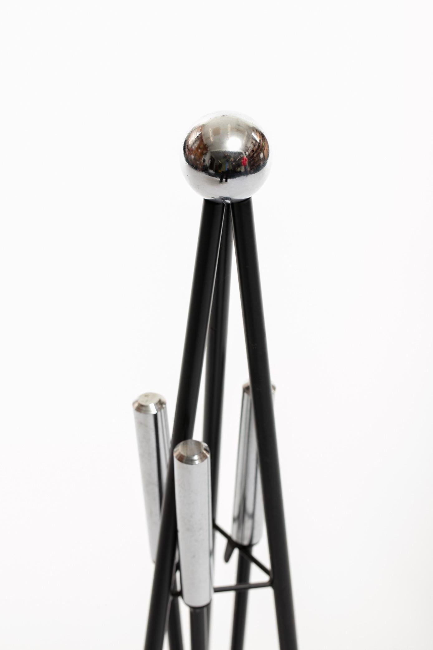 Set of modernist fireplace tools. An iron stand punctuated with nickel ball, nickel handled tools hang from the stand. This could be a nice sculptural addition you your fireplace. Want to see more beautiful things? Scroll down below and click 