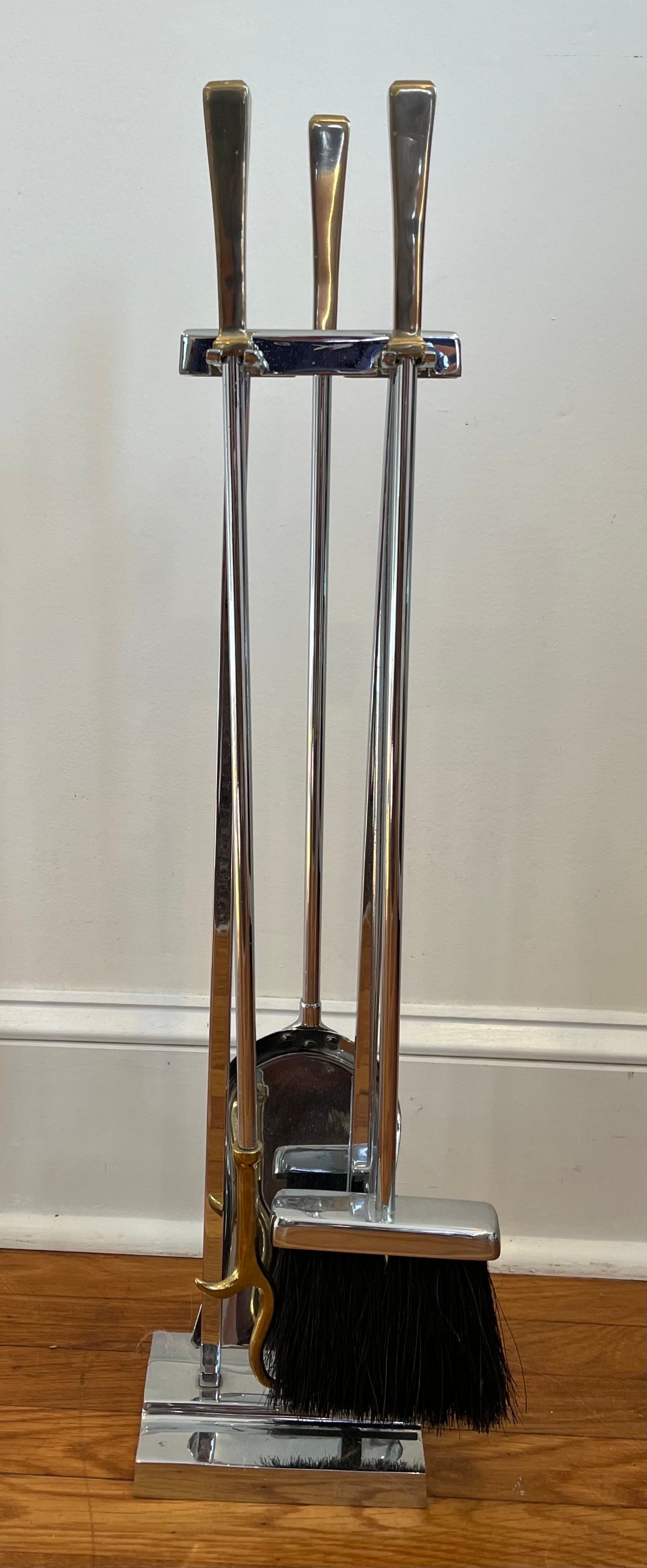 Sharp and sophisticated modernist fireplace tools in the manner of Danny Alessandro for Holly Hunt and Karl Springer. Chrome or Nickel with Brass handles and poker tip. Set includes, stand, poker, shovel and brush.