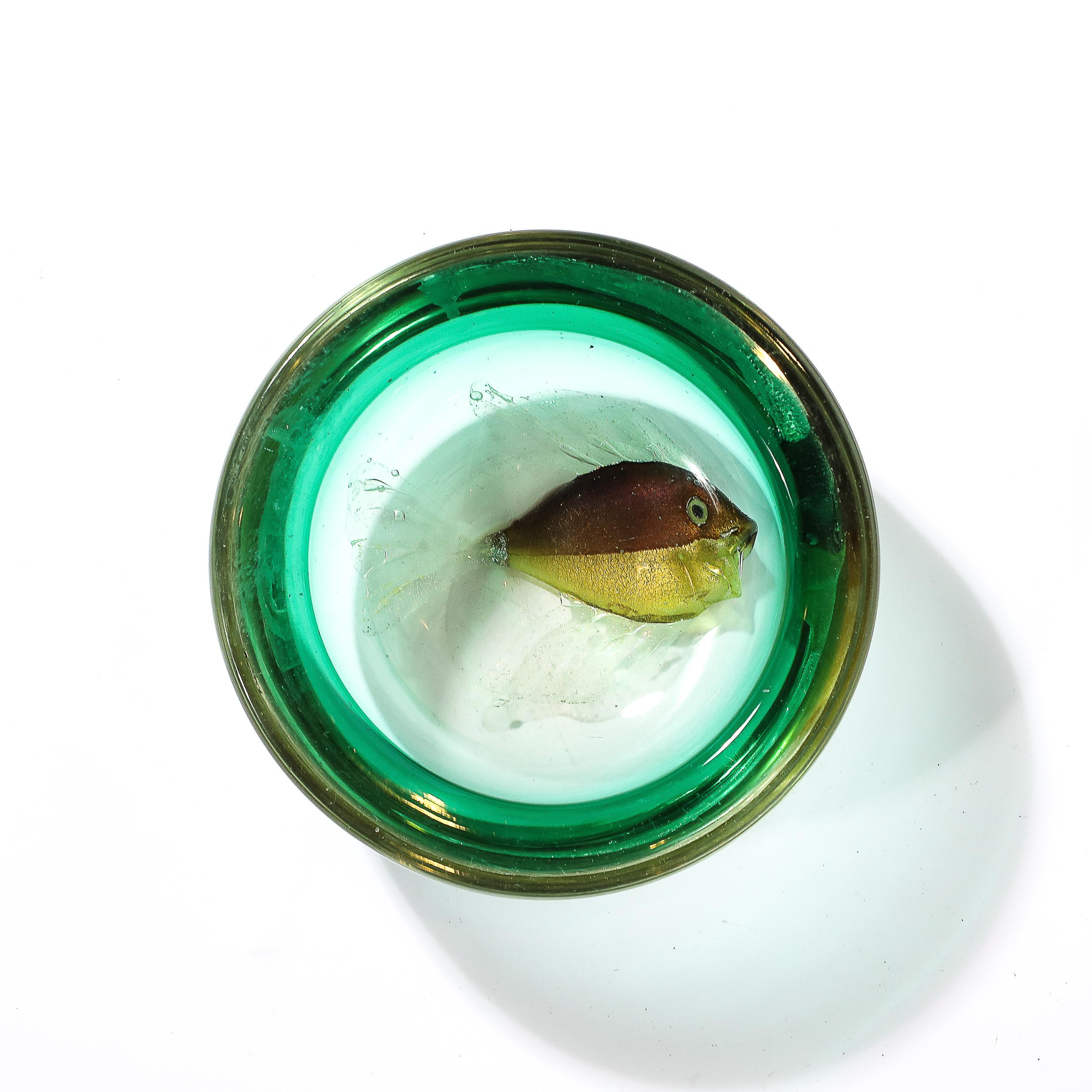 This exquisitely achieved Mid-Century Modernist Hand-Blown Murano Glass Bowl in Viridian with Fish Motif is rendered by the esteemed glass artist Alfredo Barbini and originates from Italy, Circa 1950. Featuring a round composition with a wide lip in