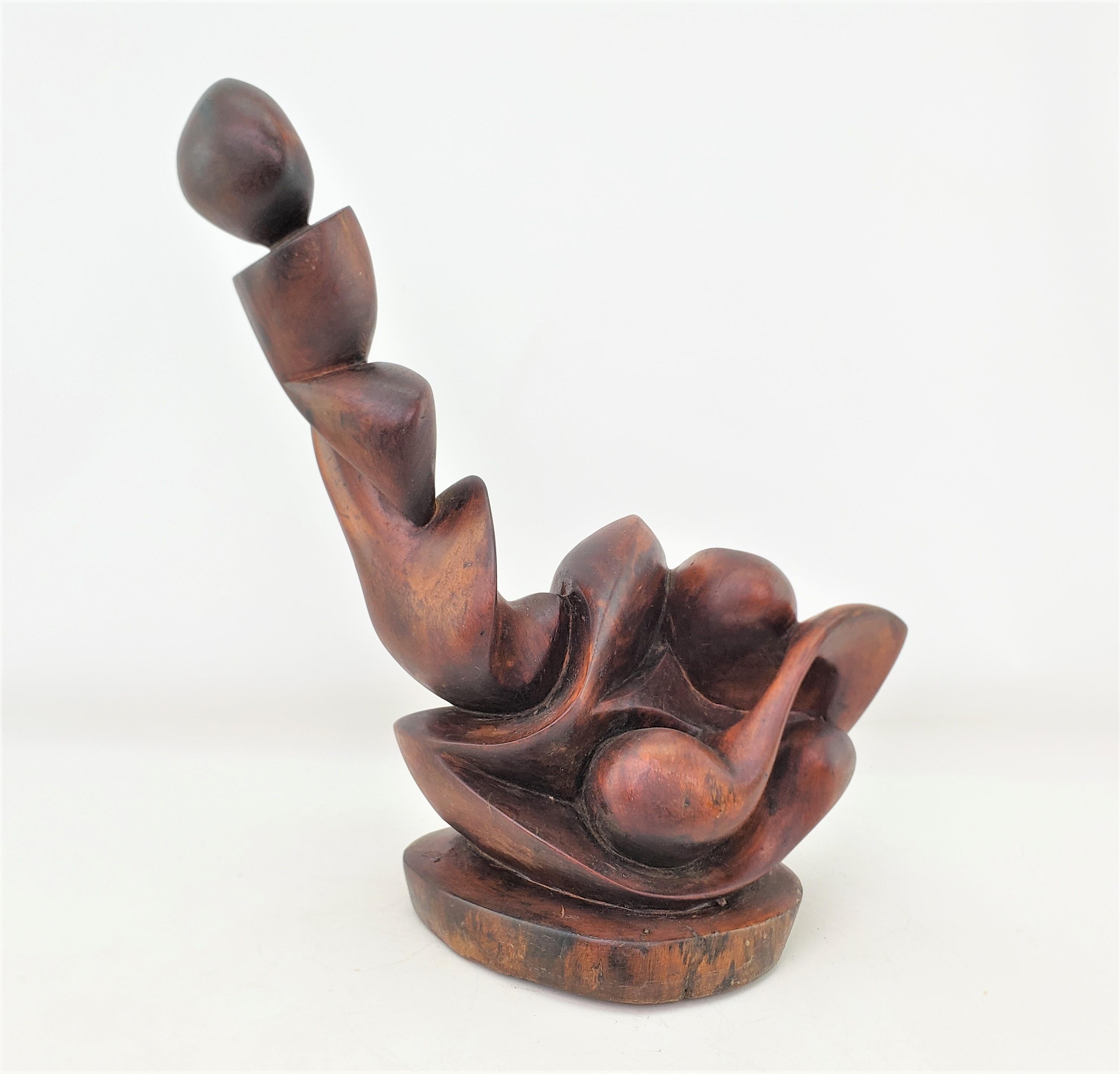 This hand carved wooden sculpture is unsigned, but presumed to have originated from the United States and date to approximately 1969 and done in the period Mid-Century Modern style. The sculpture is composed of walnut on a pine base and is hand