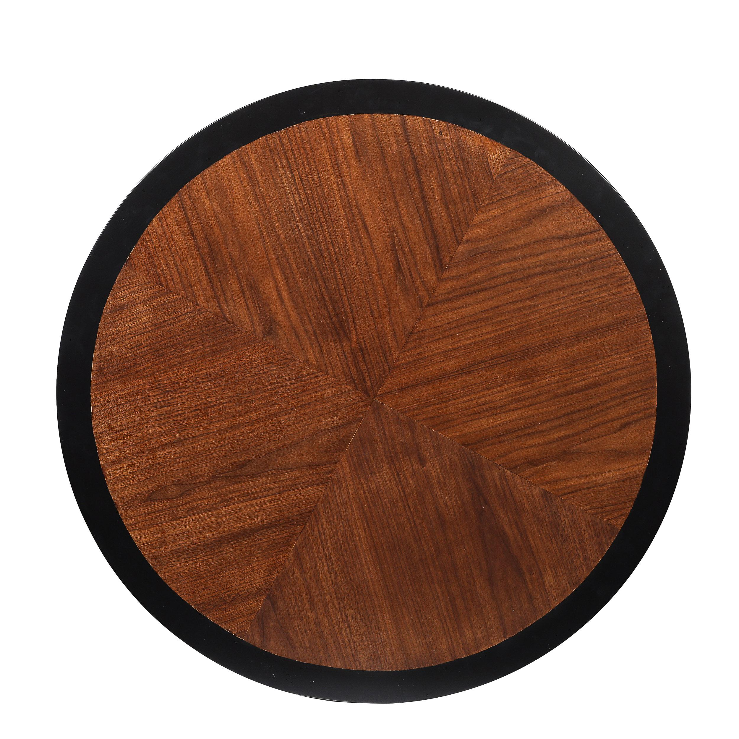 Elevate your interior with this Mid-Century Modernist Game Table, crafted in America circa 1950. This exquisite piece features stunning book-matched walnut surfaces, showcasing the wood's intricate grain patterns. The ebonized detailing provides a