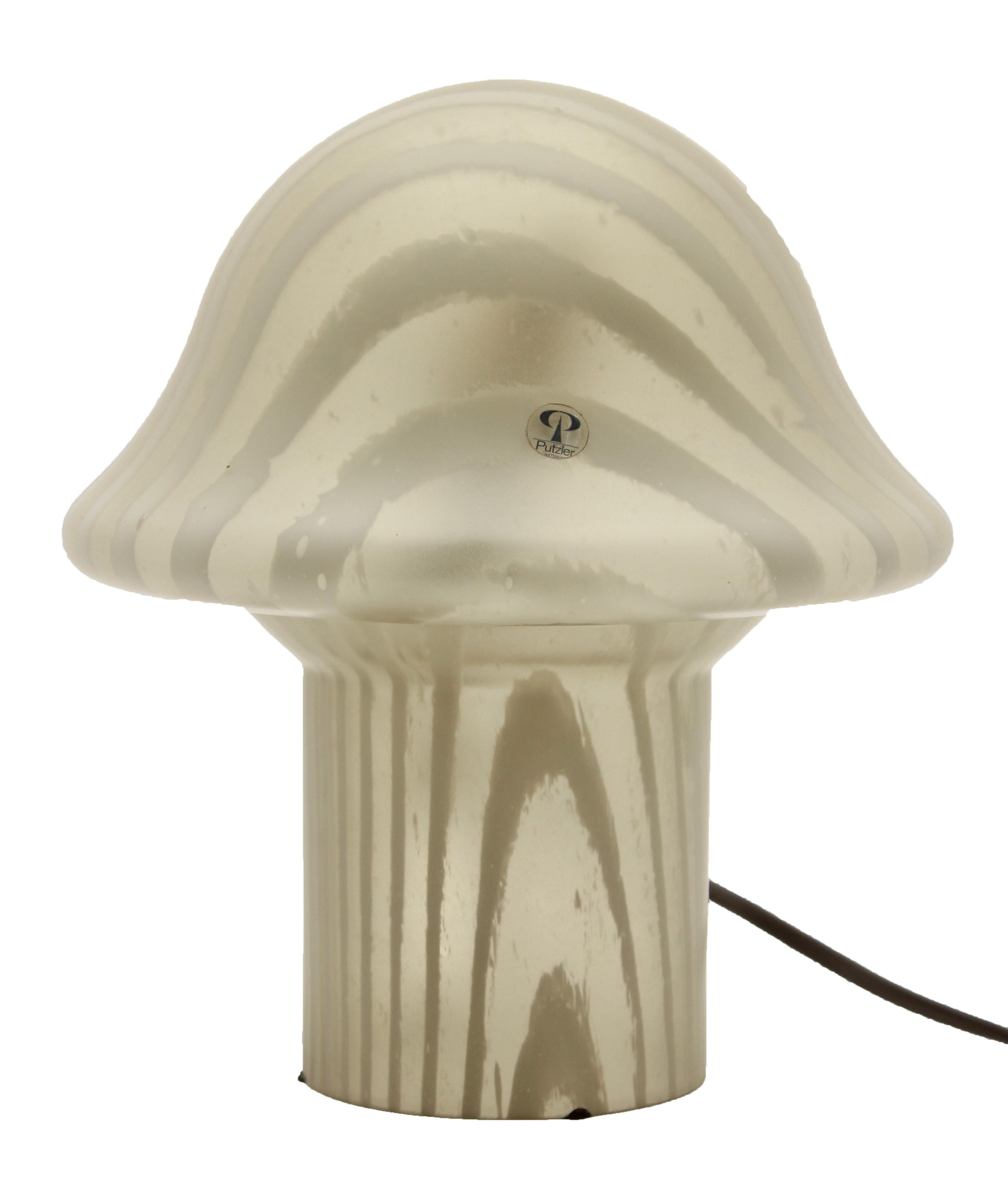Unique Mid-Century Modernist German 1960s mushroom table lamp by Peill & Putzler

This unique Mid-Century Modernist German 1960s table lamp was designed by Peill & Putzler. It features a mushroom design made of hand blown frosted glass with hues