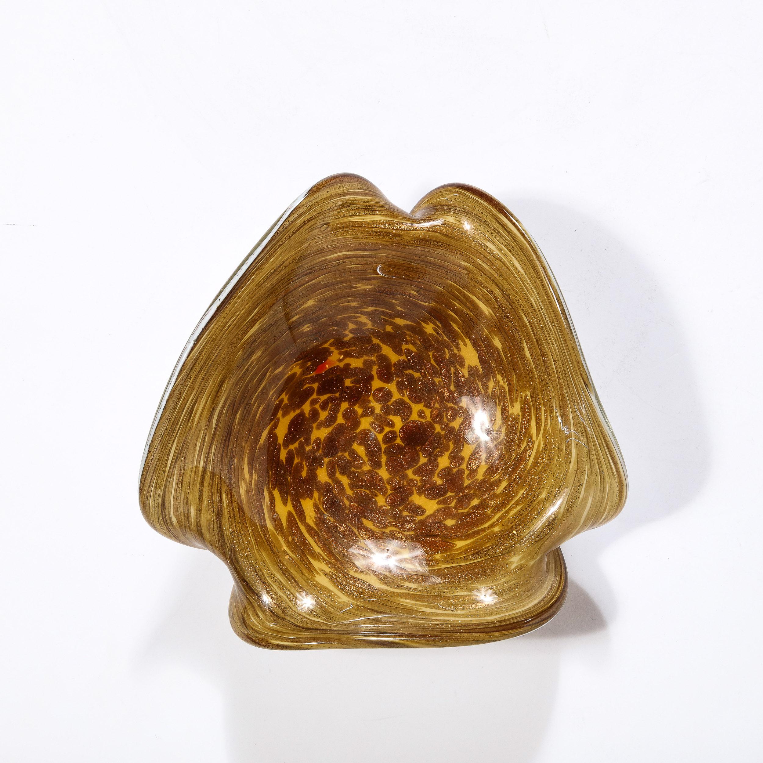 This beautiful Mid-Century Modernist Hand-Blown Murano Glass Dish Originates from Italy, Circa 1950. Featuring beautiful hues of Yellow Ocre that spiral within lighter tones to create unique and dynamic moments characteristic of Hand-Blown Glass.